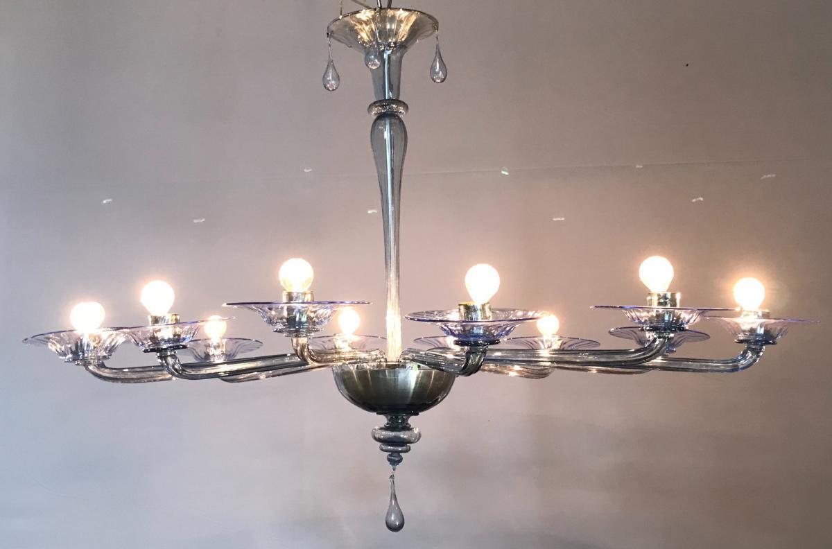 Italian chandelier by Venini in Murano light-blue glass transparent, composed by transparent twelve arms with cups in transparent and light blue, all parts were made and realized in the Murano Island, circa 1950s. The chandelier is in very perfect