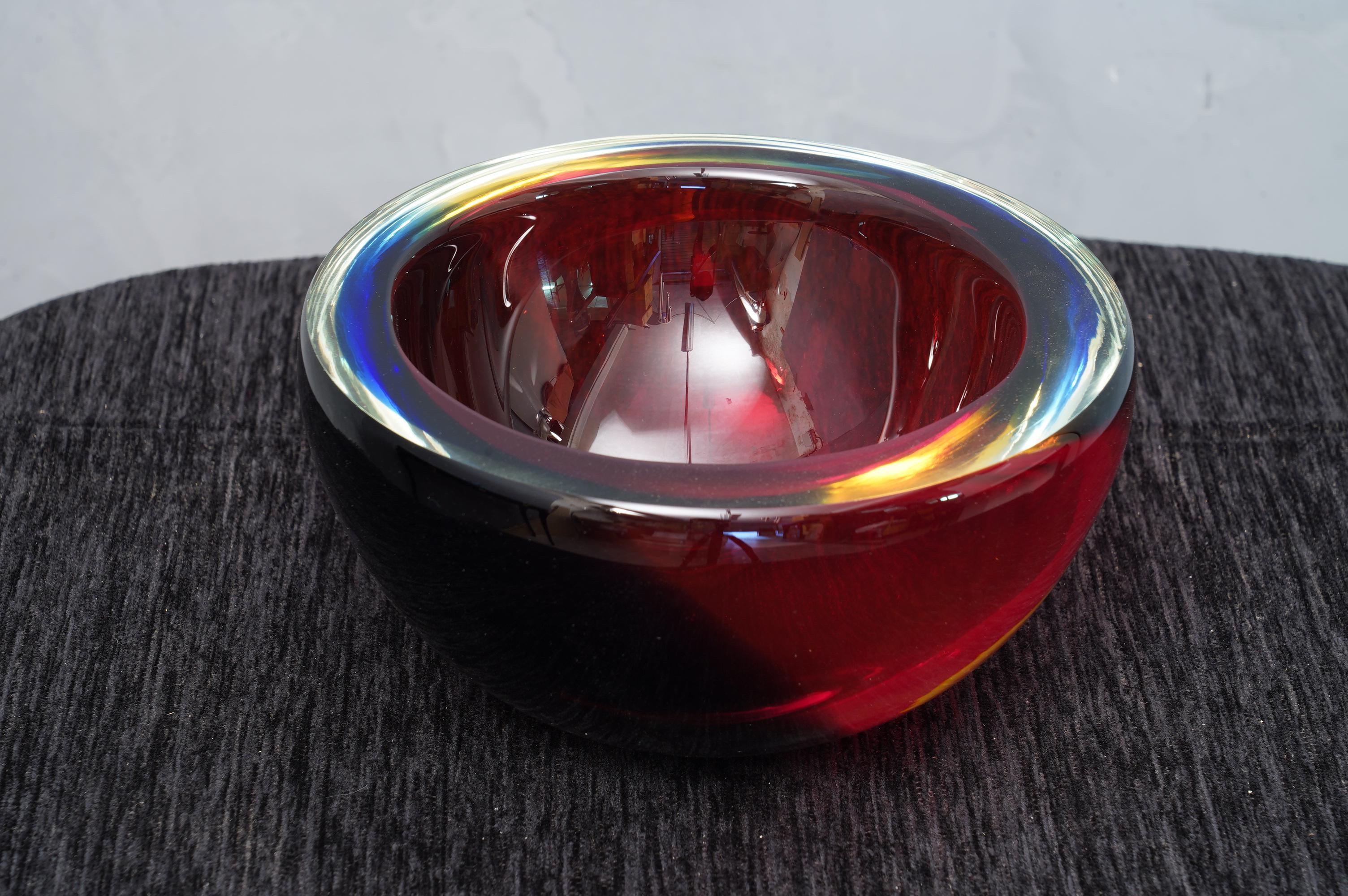 Ashtray formed by a particular submerged glass, signed Venini, with a wonderful double black and red color.

The ashtray is in Murano glass, circular in shape, and with a particular transparent red and black color. The signature is placed on the