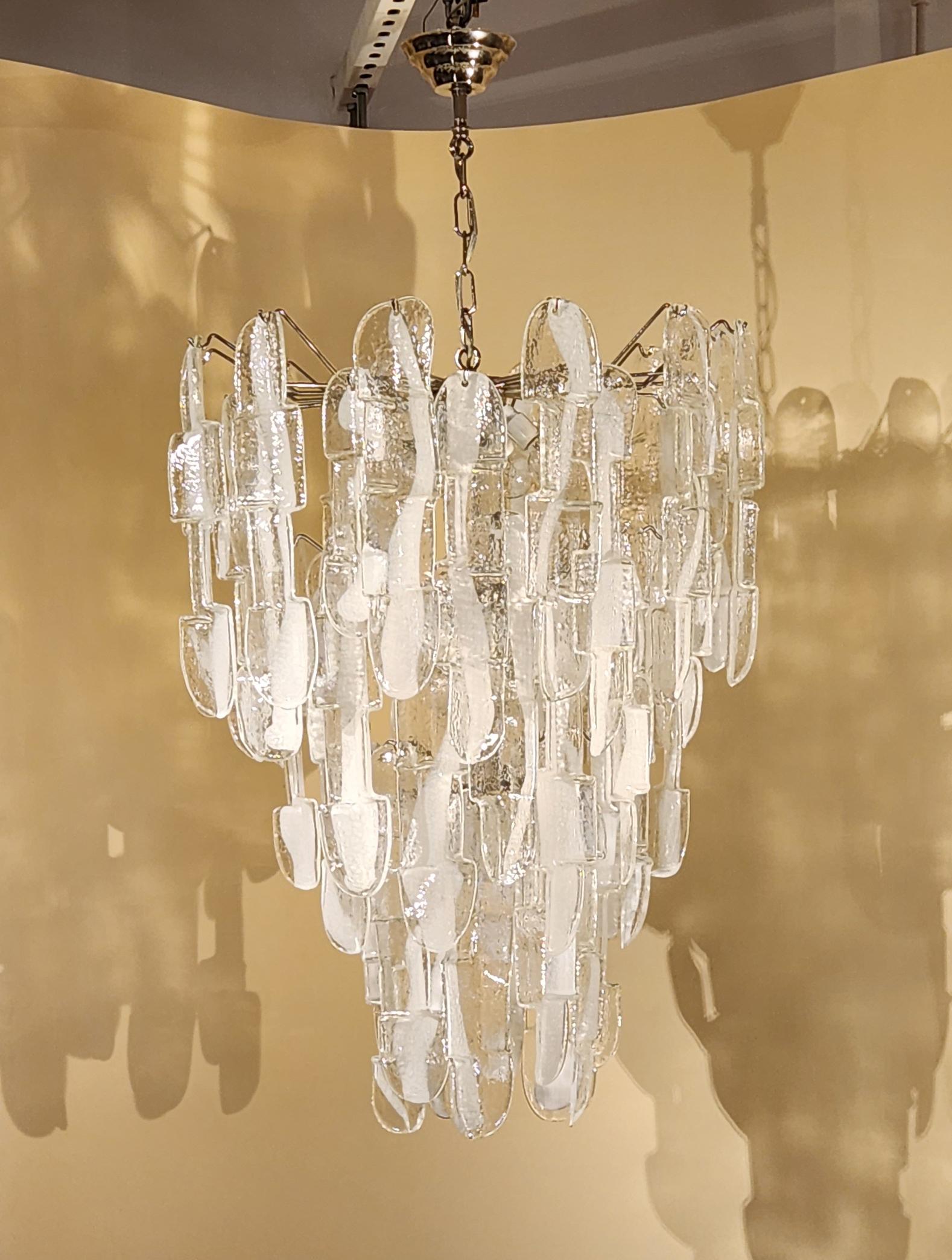 A large magnificent Mazzega Murano Art glass chandelier from Italy, circa 1960. The chandelier has a chrome framing and contains 50 large art glass prisms. It takes 8 light bulbs.
