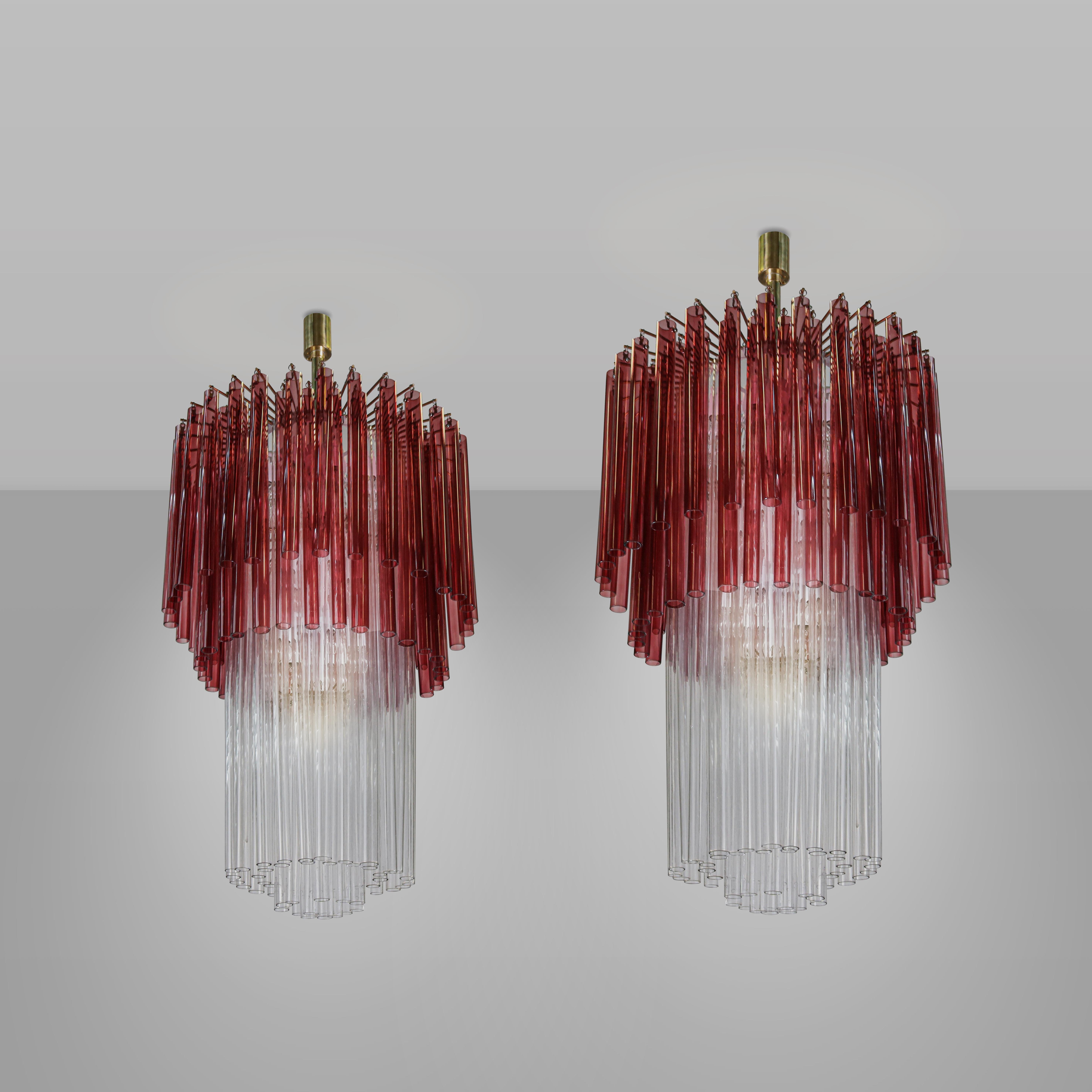 Pair of chandeliers with brass structure and beautiful decorative elements from Venini's Canne series, a classic that allows versatile conformations with relatively simple Murano glass elements to be combined in shapes and colors that are always