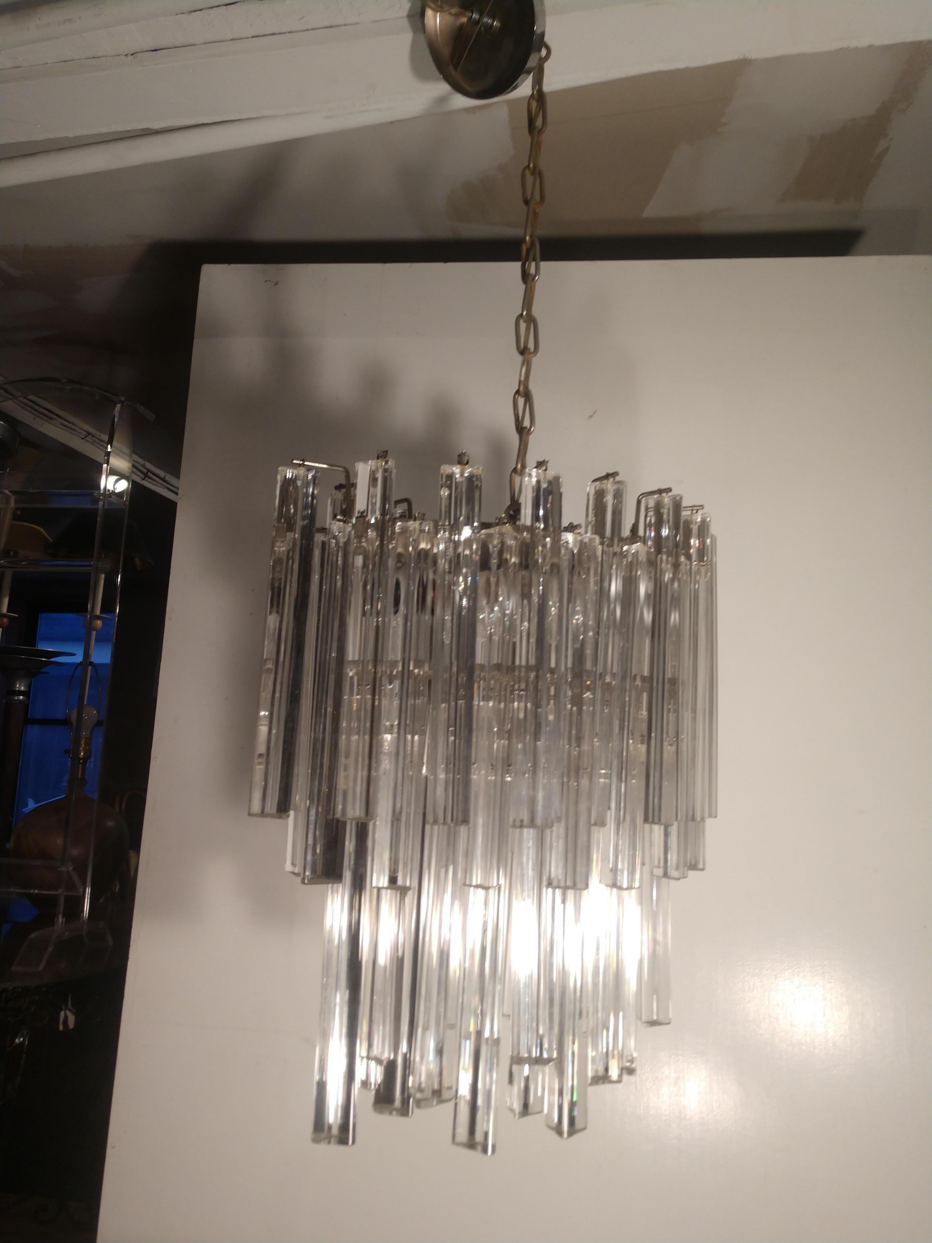 Fabulous Venini chandelier in an oval shape. 4 lights to illuminate the triangular prism. In excellent vintage condition with minimal wear. Total length is 42 with original canopy and chain.