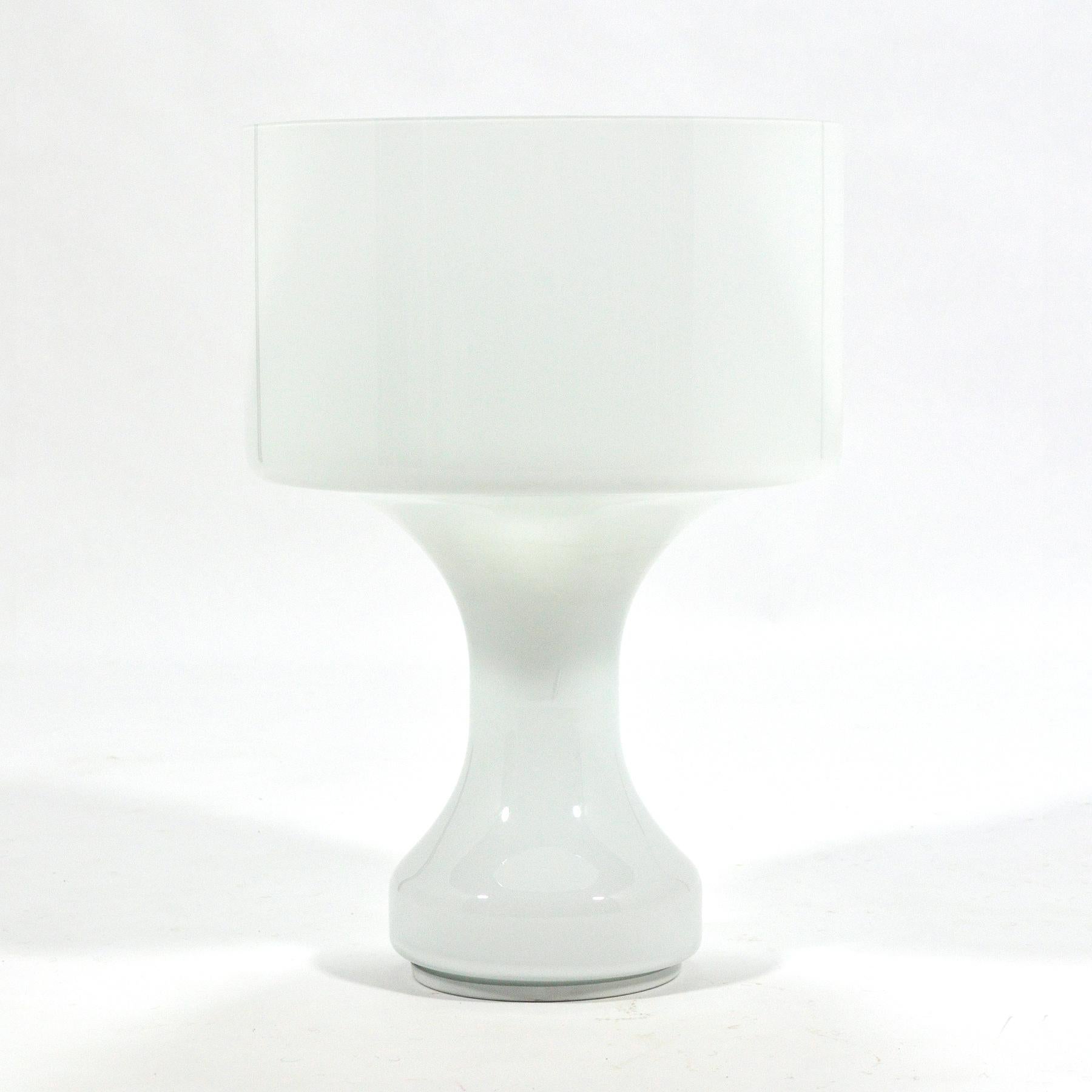 This beautiful Italian lamp takes a Minimalist aesthetic to a traditional lamp shape, combining the base and shade into a single form made of white glass. A second glass diffuser with a hole to release heat rests inside the shade and there is an