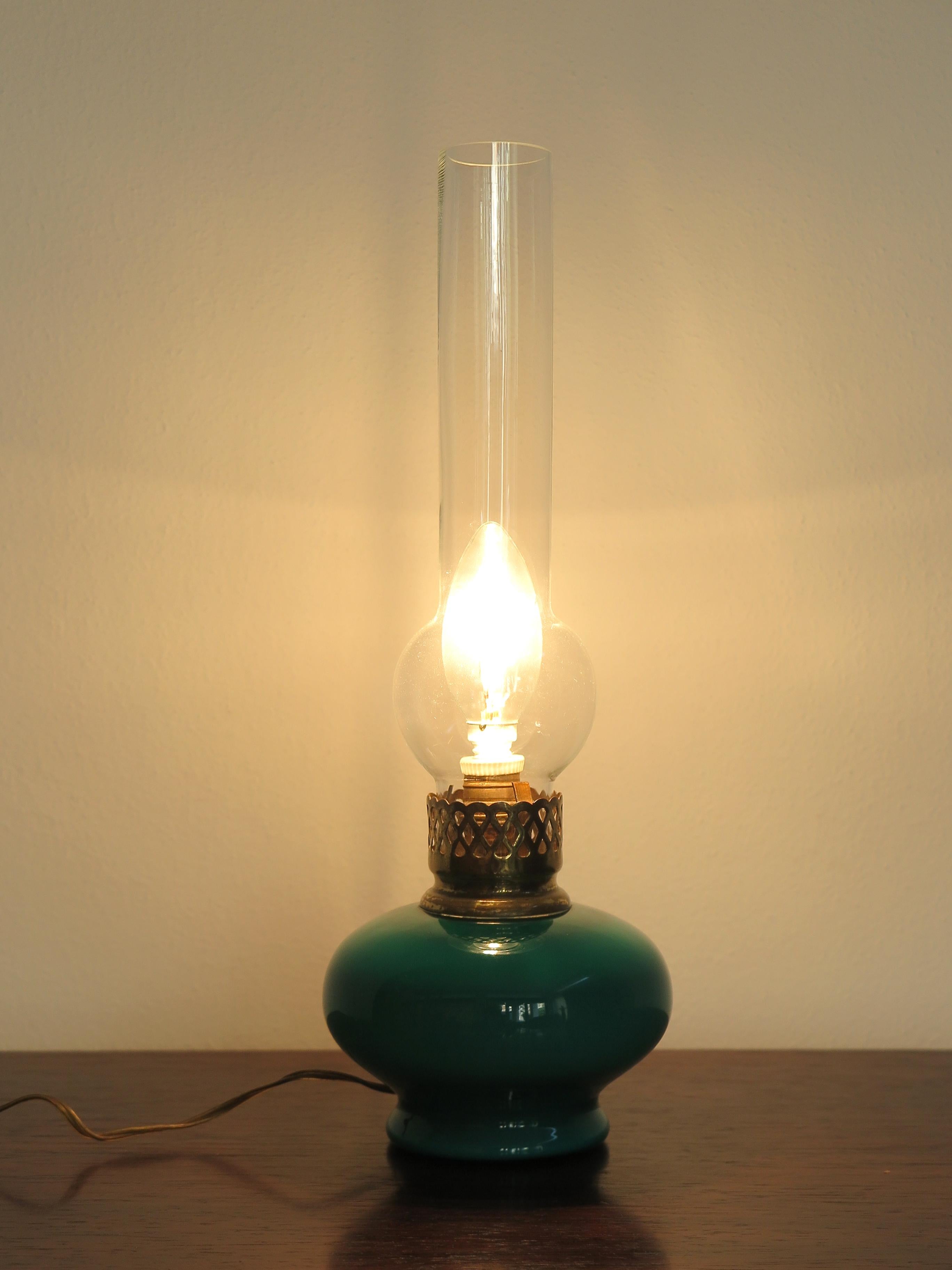 Italian midcentury modern design table lamp produced by Venini Murano with colored opaline glass base and transparent glass diffuser and brass lamp holder, manufacturer's adhesive label under the base, production Italy 1950s.

Please note that the