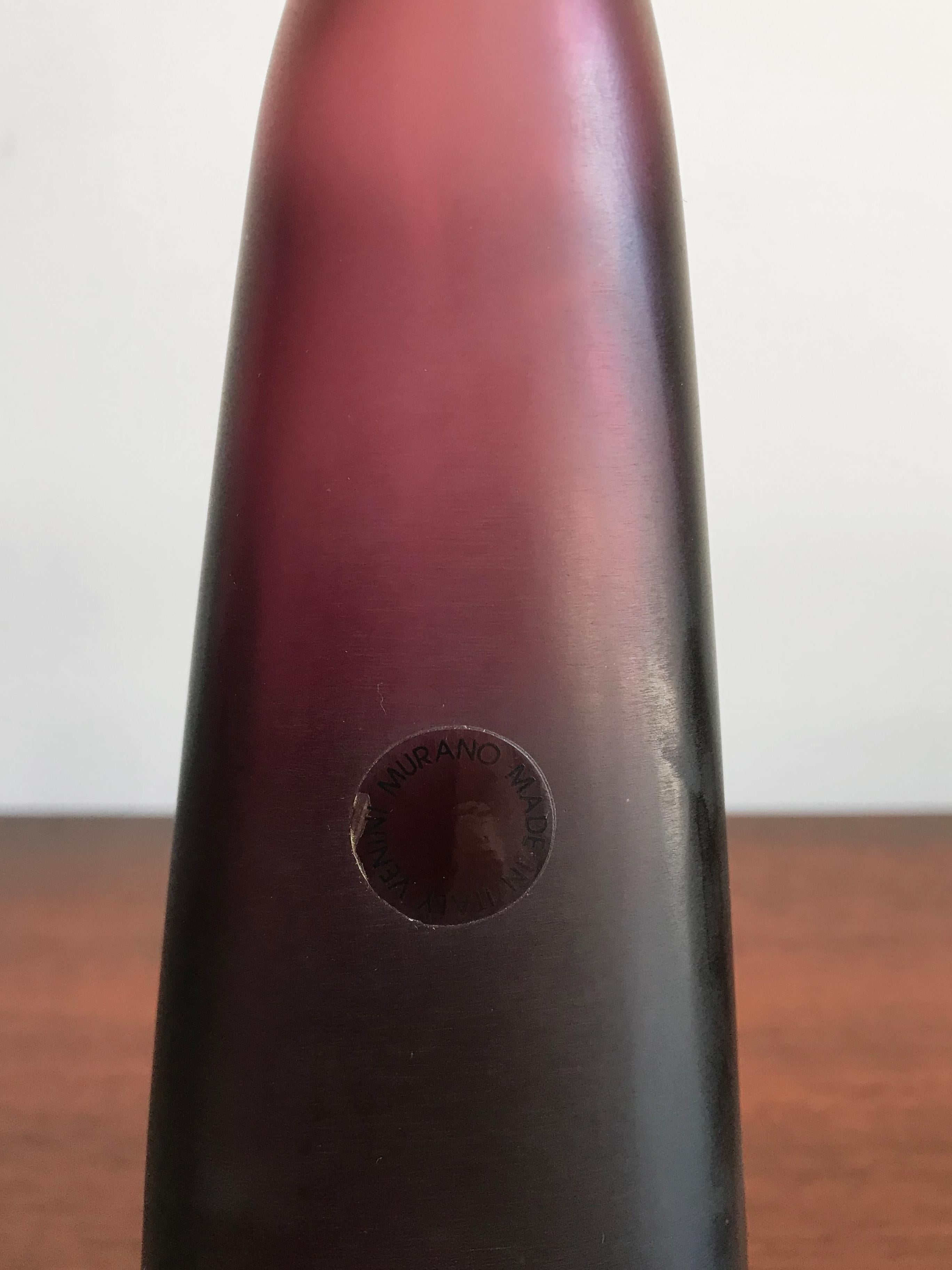 Amazing and fabulous very rare Italian handmade and blown bottle in bordeaux color glass with stopper, from the “Velati” series designed and produced by Venini Murano in 1995.

Logo Venini 1995 engraved by the producer on the bottom.
 