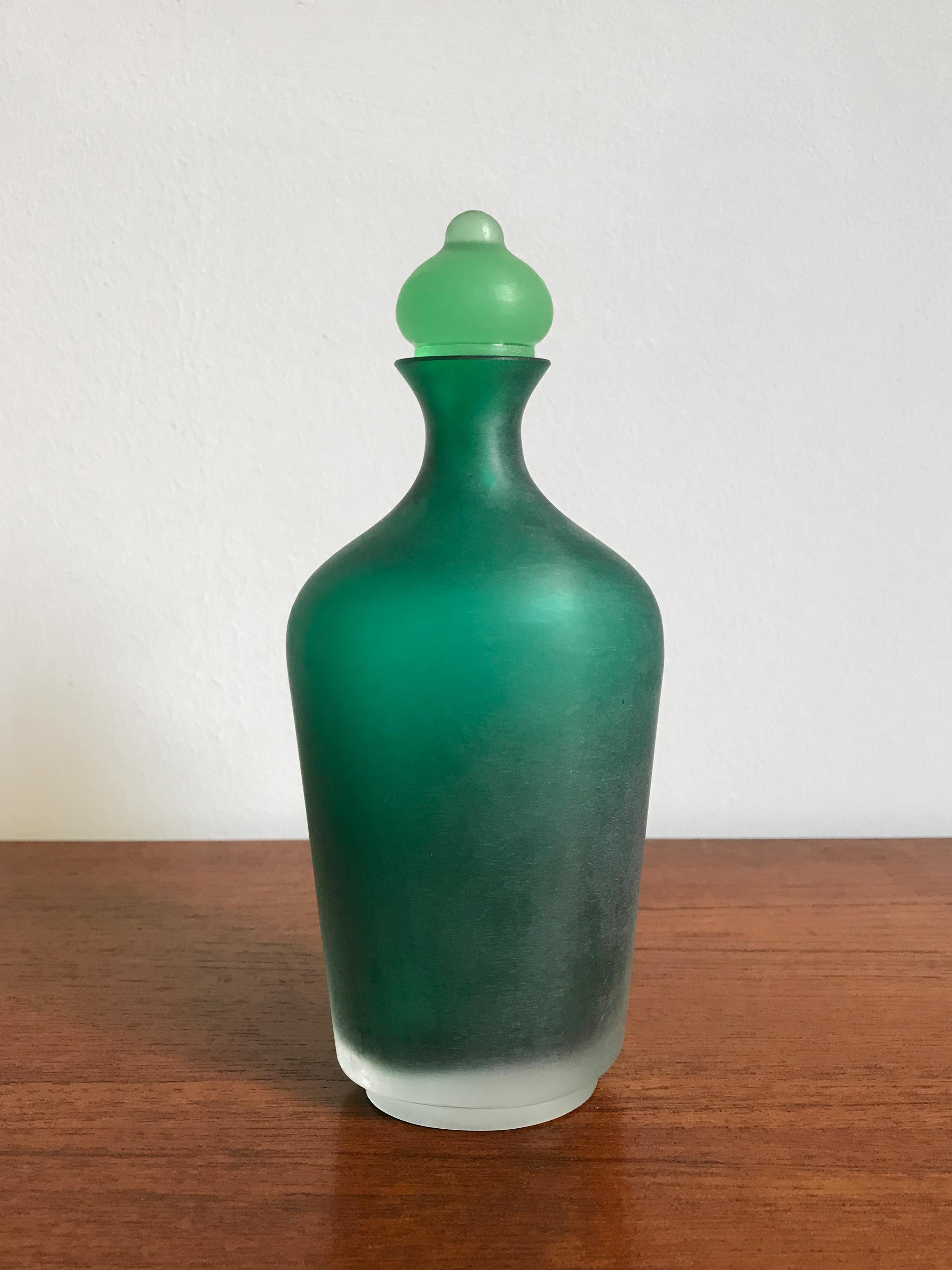 Amazing and fabulous very rare Italian handmade and blown bottle in light green color glass with stopper, from the “Velati” series designed and produced by Venini Murano in 1996.

Original Venini Murano label made in Italy and engraved by the