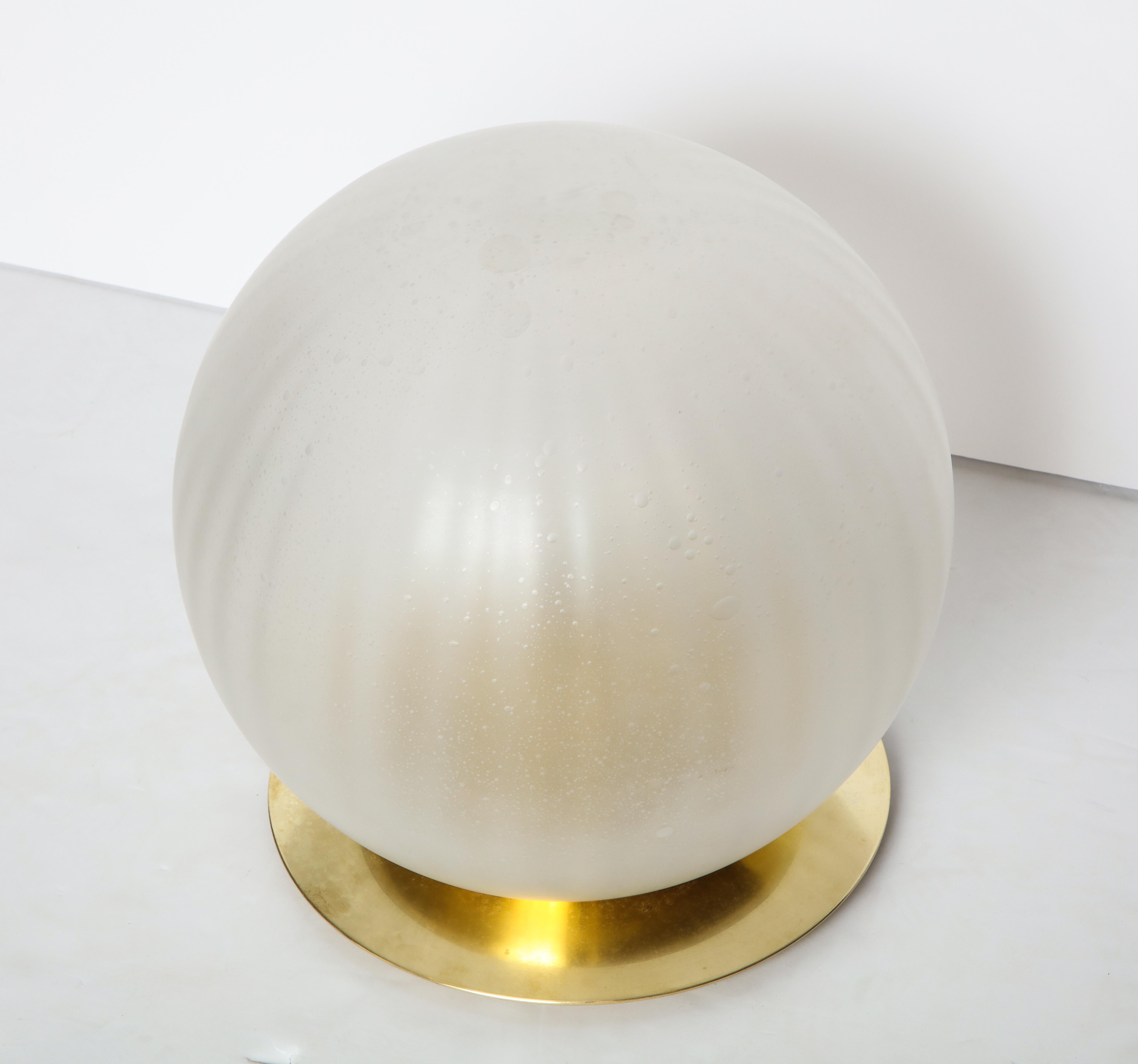 Venini opaque mottled and ribbed glass table lamp mounted on a circular base. 
Italy, circa 1960 
Size: Globe: 15 1/2