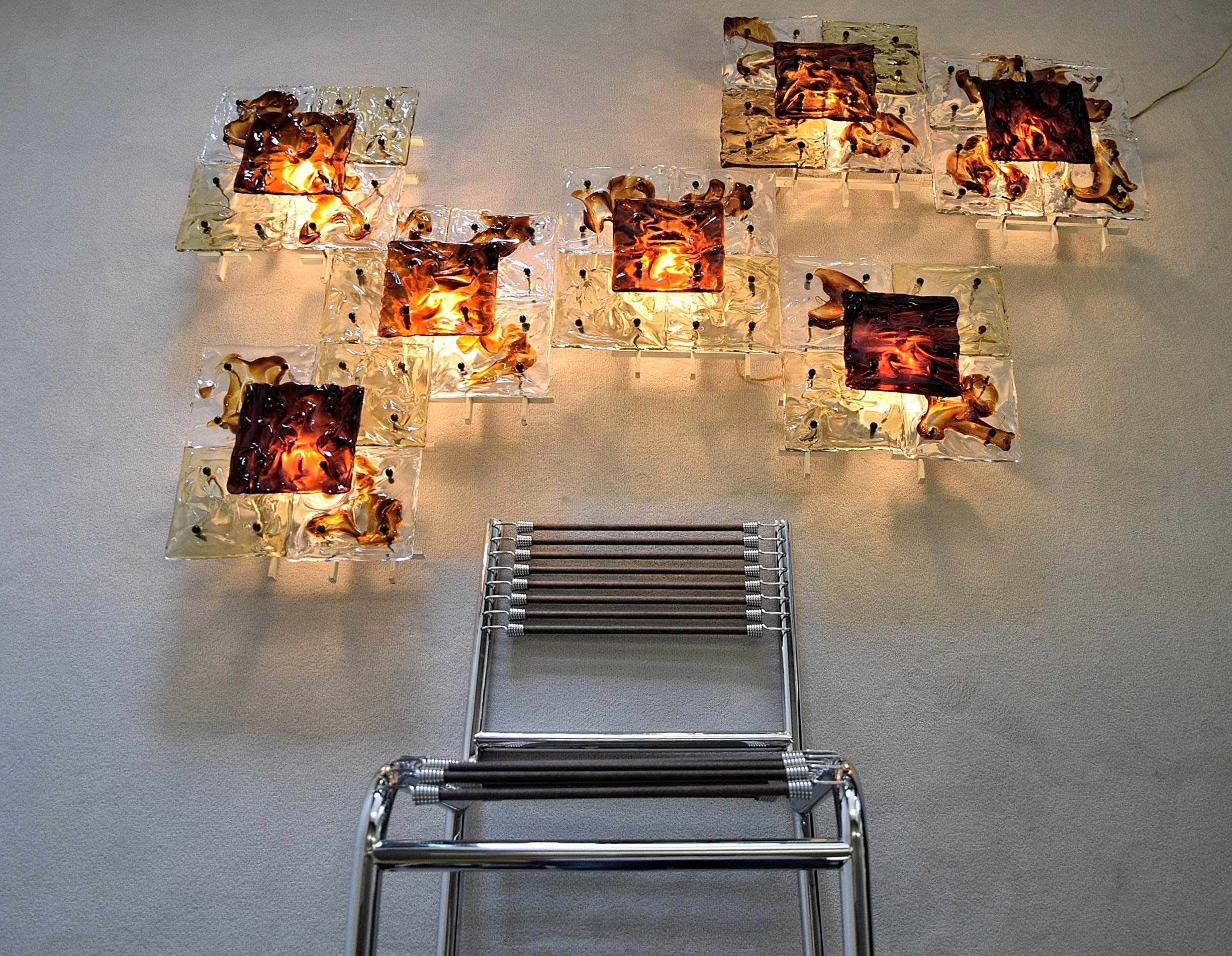 Set of amazing and very rare and luxury Italian wall lights or sconces designed by Toni Zuccheri and produced by Venini Murano, model Patchwork,
hot-worked transparent glass, painted metal frame and brass details, 1970s. These beautiful glass