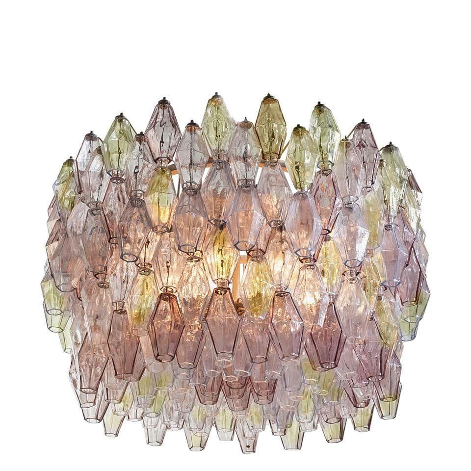 Fabulous original Venini Polyhedral Murano glass chandelier by Carlo Scarpa. Rare combination of light pink and amber colored poliedri hanging from the metal tiers at several levels.
Ivory painted oval shaped frame in very good and fully original