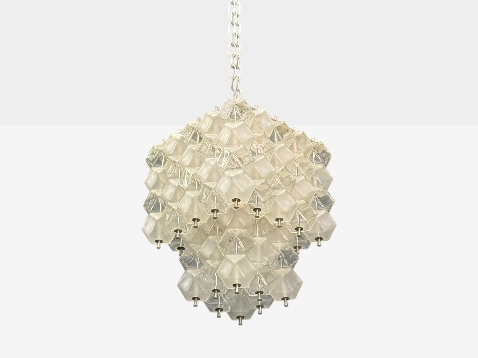 Venini Poliedri, Italian Mid-Century Modern, Faceted Glass, Metal, Geometric Chandelier, Italy, 1950s

Tiered chandelier designed and produced by Venini in Italy c. 1950s. This example features an array of geometric glass pieces, many of which are