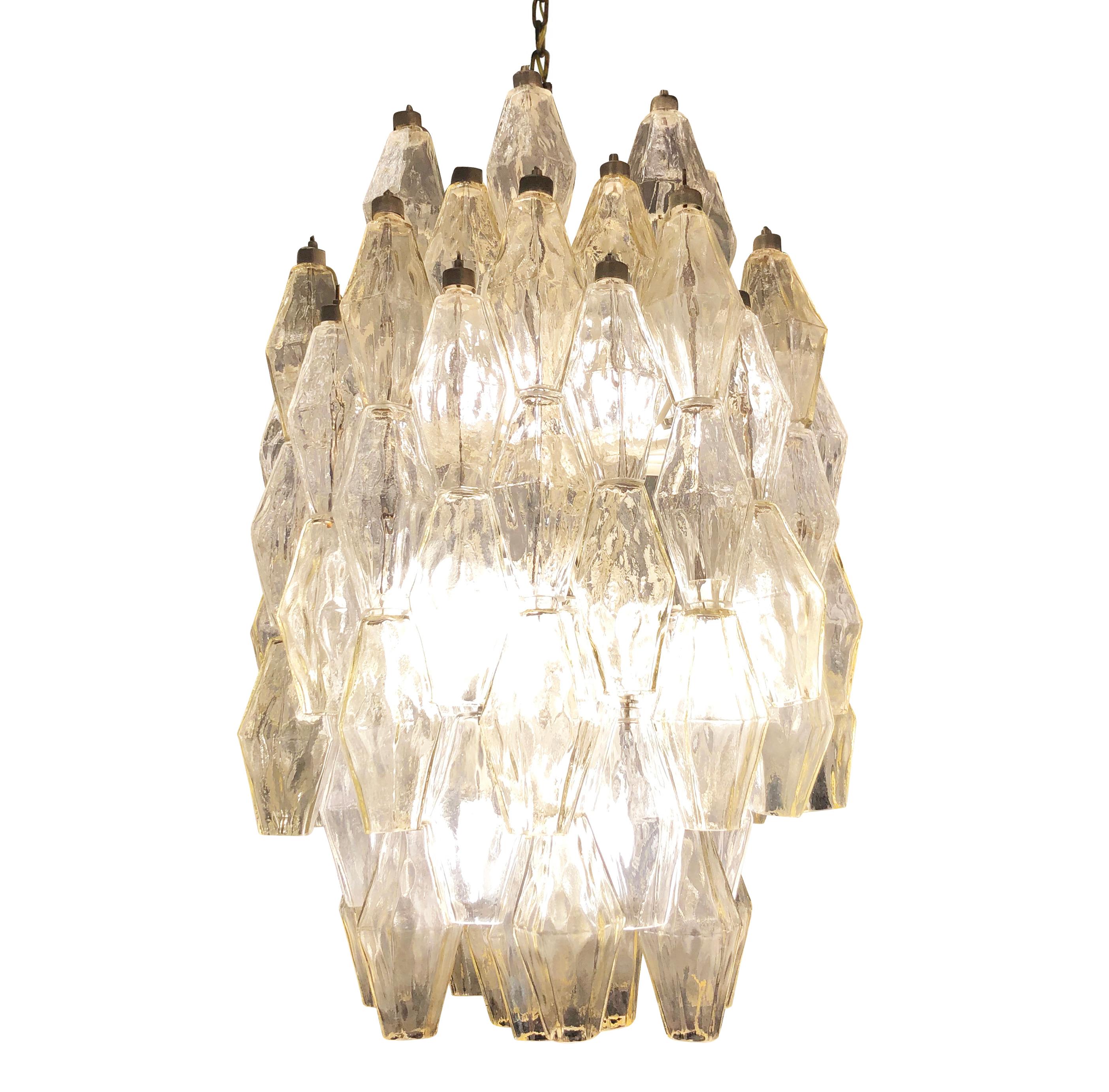 Midcentury chandelier by Venini made with their iconic poliedri Murano glasses. The glasses are a mix of clear ones and light amber ones mounted on a white lacquered frame. Ready to hang on a chain.

Condition: Excellent vintage condition, minor