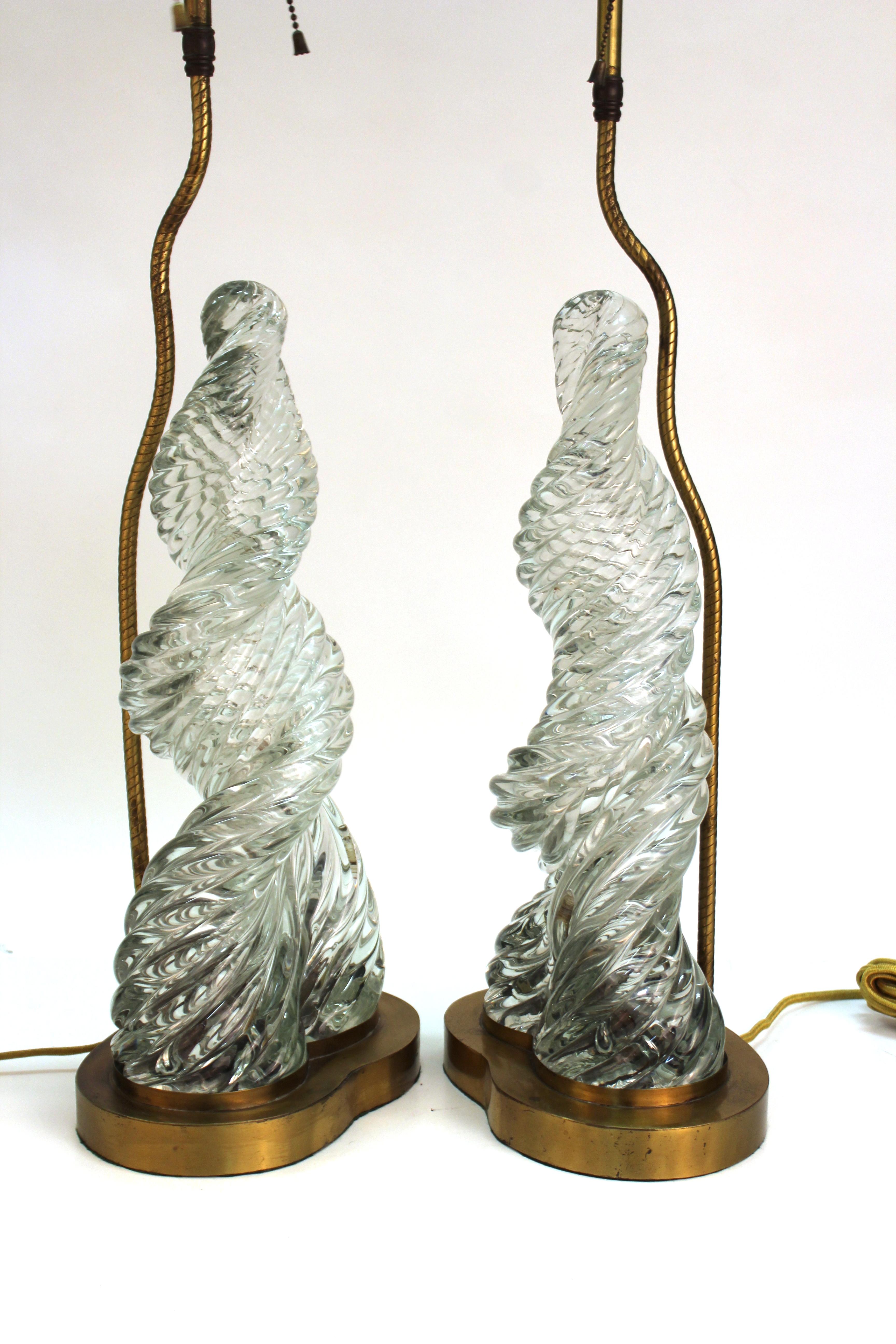 Italian Murano glass 'Diamante' pair of table lamps created by Paolo Venini and Carlo Scarpa. The pair has tall twisted swirl glass elements rising atop metal bases with brass hardware in the back holding up the light sources. The pair is in good