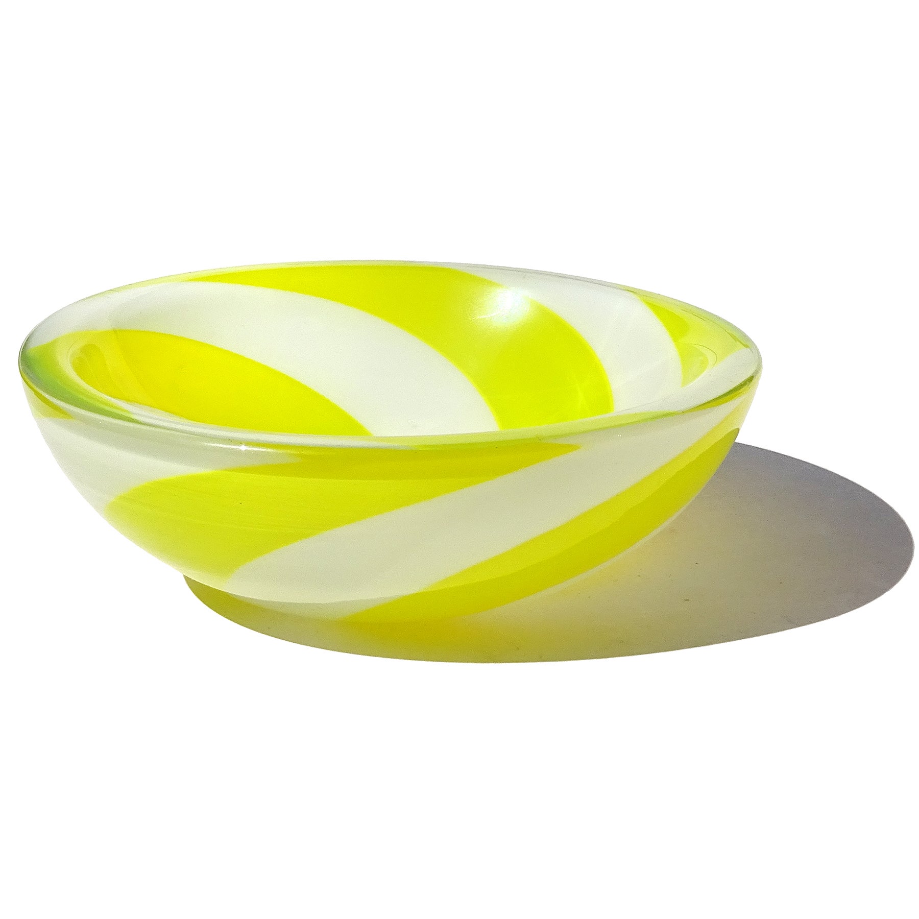 Beautiful vintage Murano hand blown yellow and white stripes optic swirl Italian art glass bowl or vide-poche. The bowl has been documented to designer Fulvio Bianconi, for the Venini company. Described as an 