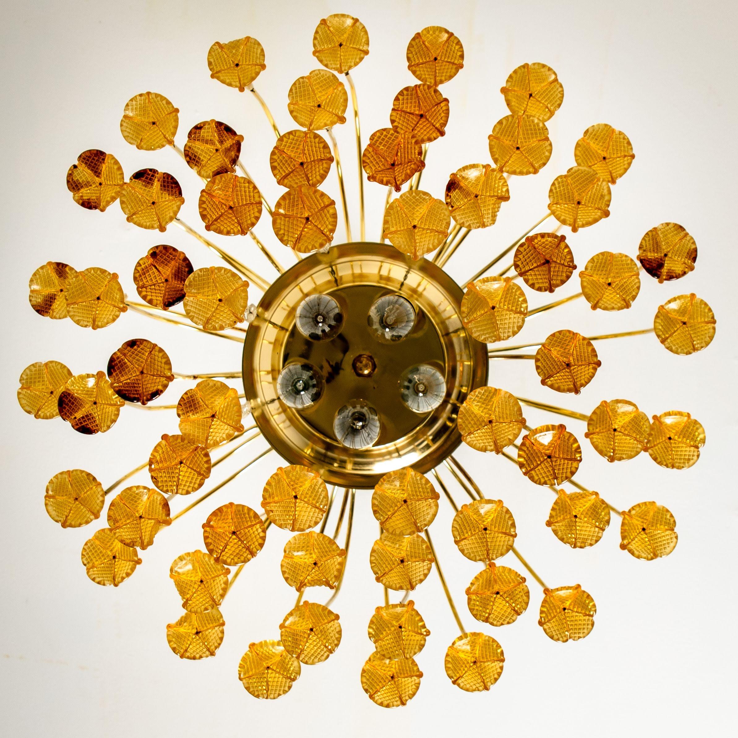 Waterfall chandelier designed and manufactured in Italy, 1960s. Several orange glass flower drops with clear glass pearls. 
Decorative brass plate frame with three-light fittings. Illuminates beautifully (see images). 

Heavy quality and in very