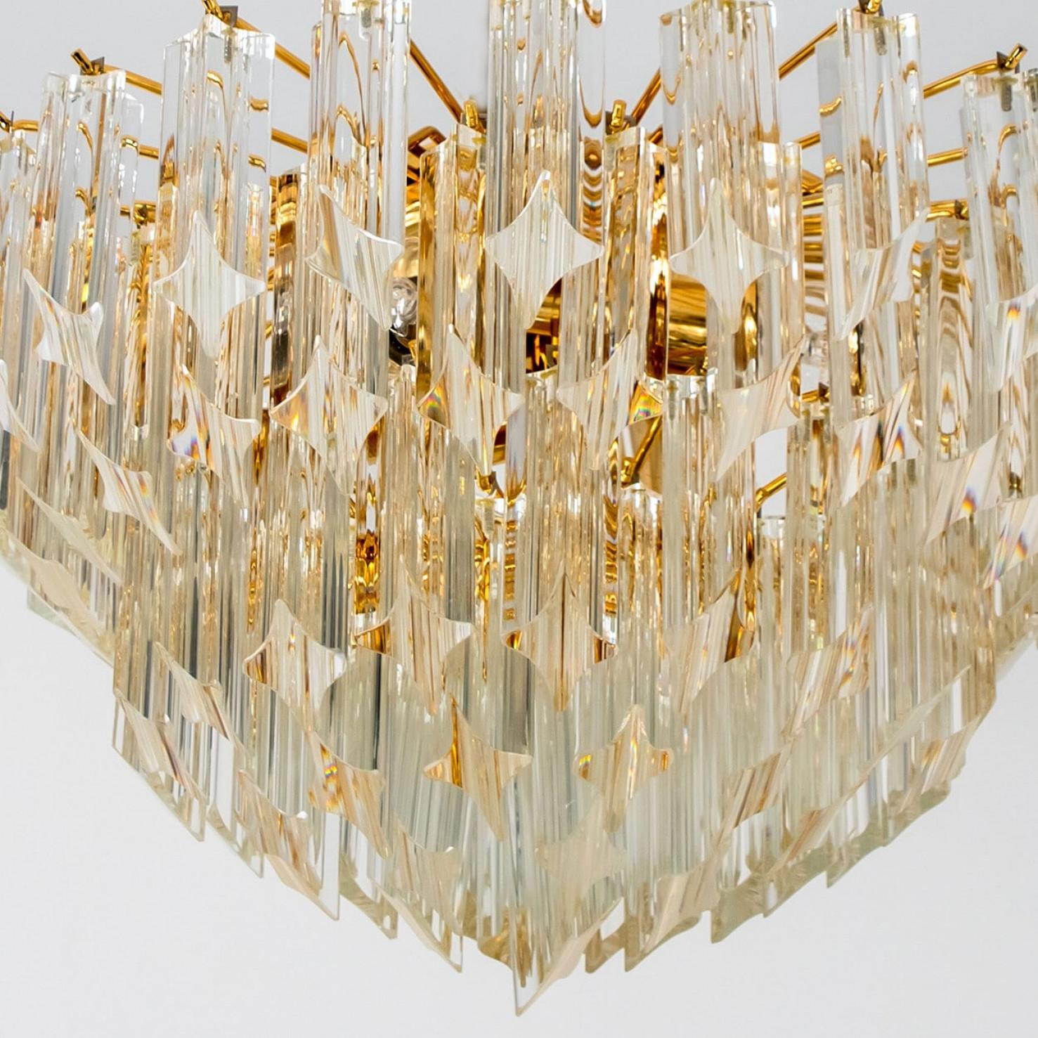 Beautiful chandelier featuring five tiers of multiple long crystal clear glass 