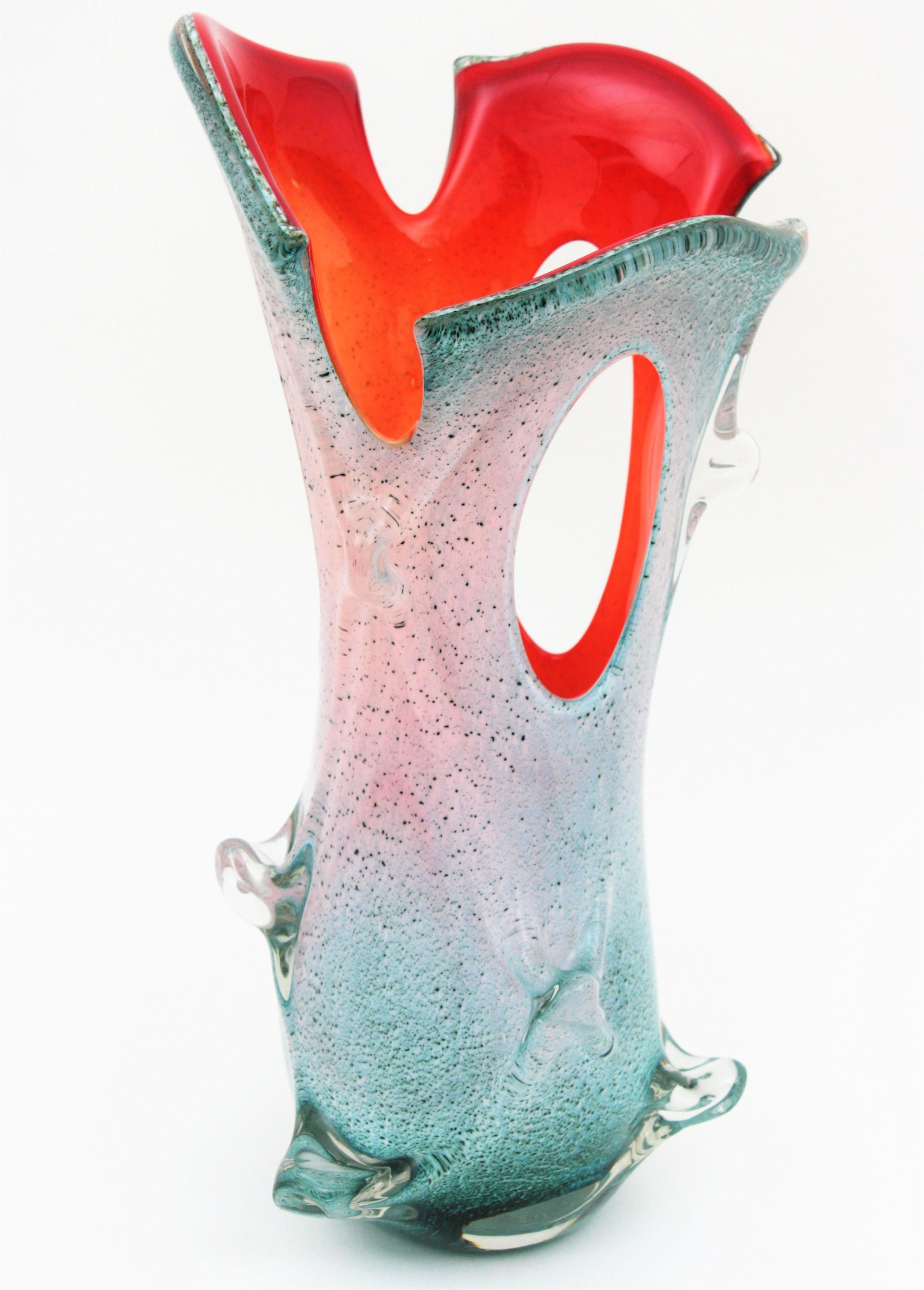 Monumental Mid-Century Modern colorful organic shaped Murano glass Forato (hole) large flower vase, Italy, 1950s.
Manufactured in the style of Fulvio Bianconi and Venini in a gradient turquoise or white glass and red or orange glass at the interior