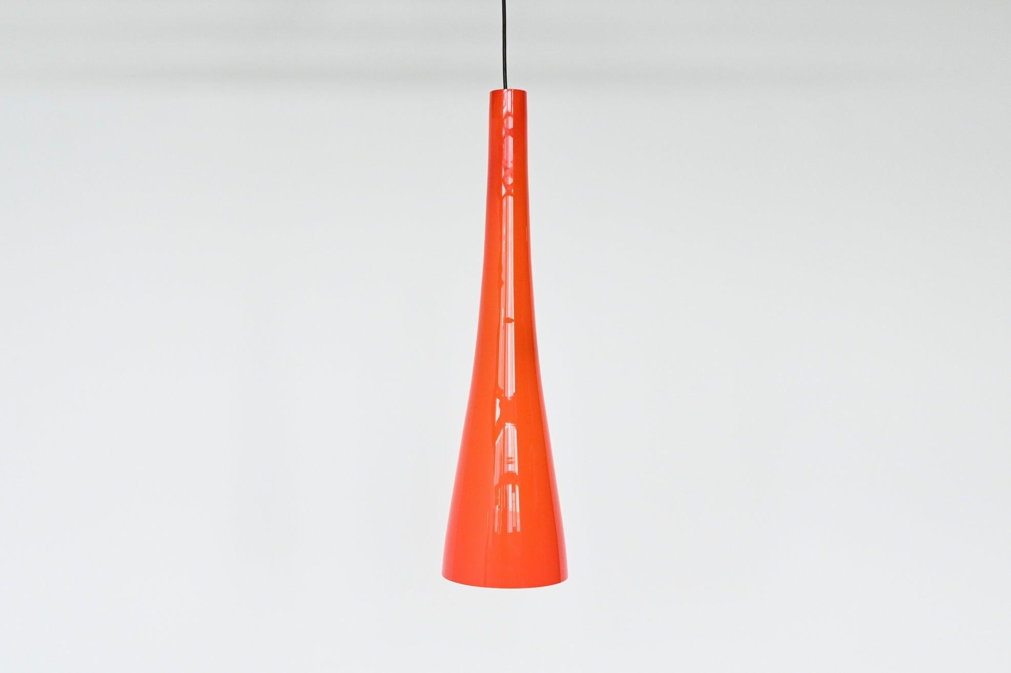 Very nice pendant lamp in the style of Venini, but by unknown designer or manufacturer, Italy, 1960. This lamp is made of hand blown thick clear orange colored glass with a white inside. That makes sure that these lights give a nice and warm light