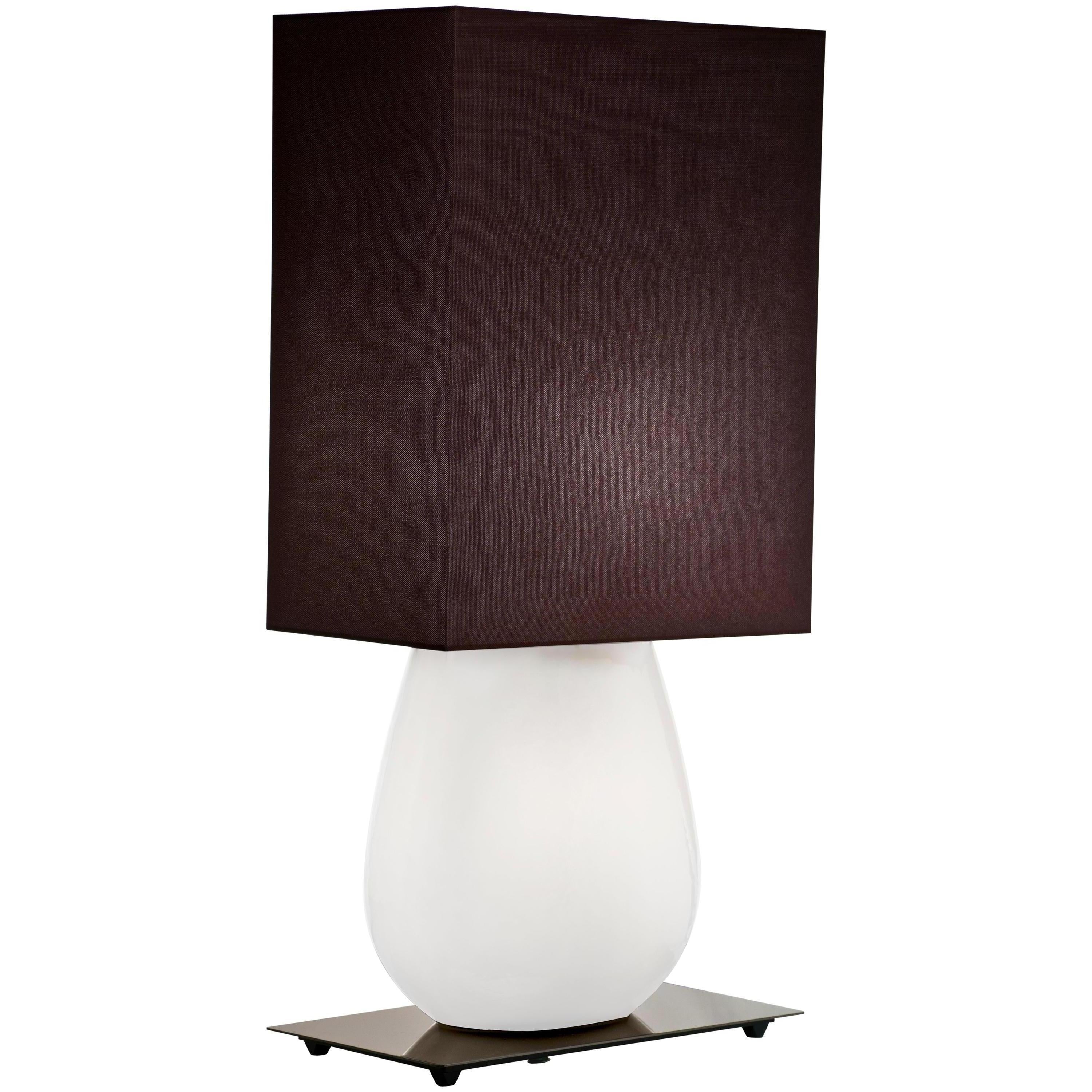 Sultani table lamp, designed by Leonardo Ranucci and manufactured by Venini, features an handmade blown glass body with fabric shade. Indoor use only.

Dimensions: W 24.5 cm x D 40 cm x H 98 cm. Also available in a smaller version: W 20 cm x D