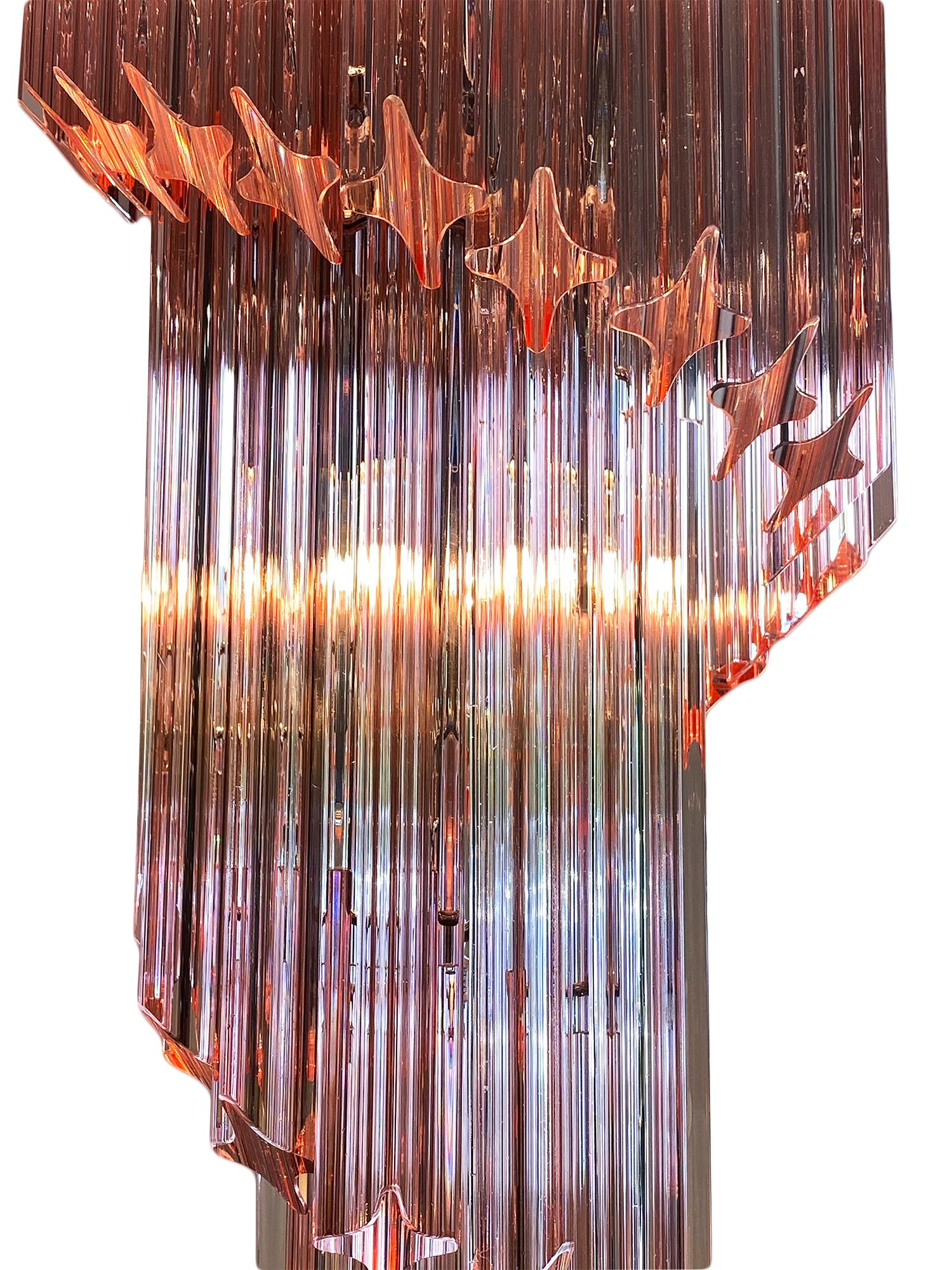 Pink Murano glass Venini “triedri” spiral chandelier. This piece by Venini is in the iconic “spirale triedri” shape and features beautiful hand-blown glass components in a pink hue. They glass is layered in a downward spiral on a chromed structure.