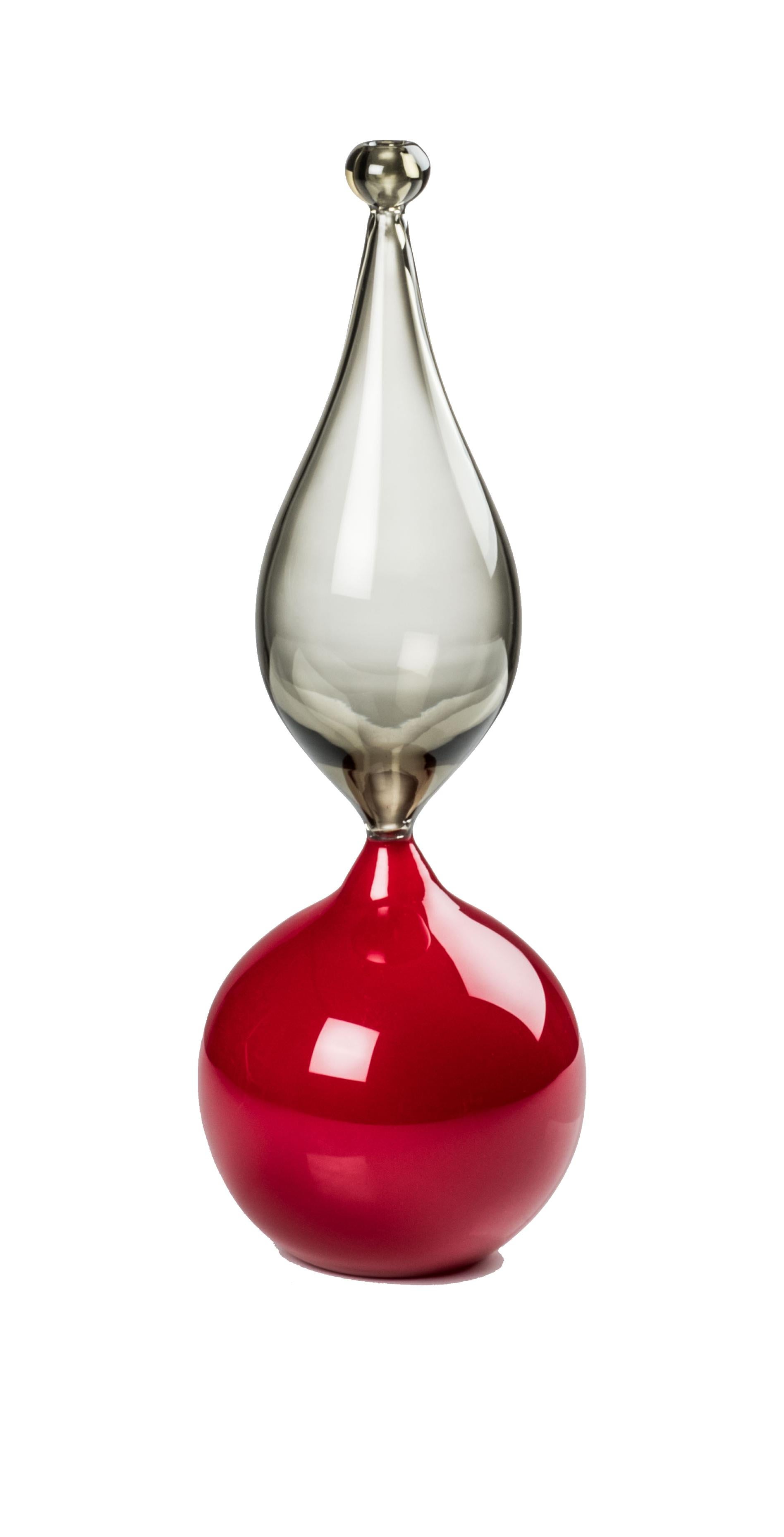 Venini glass vase with red cylindrical base, slim shaped body, and spherical head. Featured in red and grey colored glass and designed by Monica Giggisberg & Philip Baldwin in 2018. Perfect for indoor home decor as a strong statement piece for any