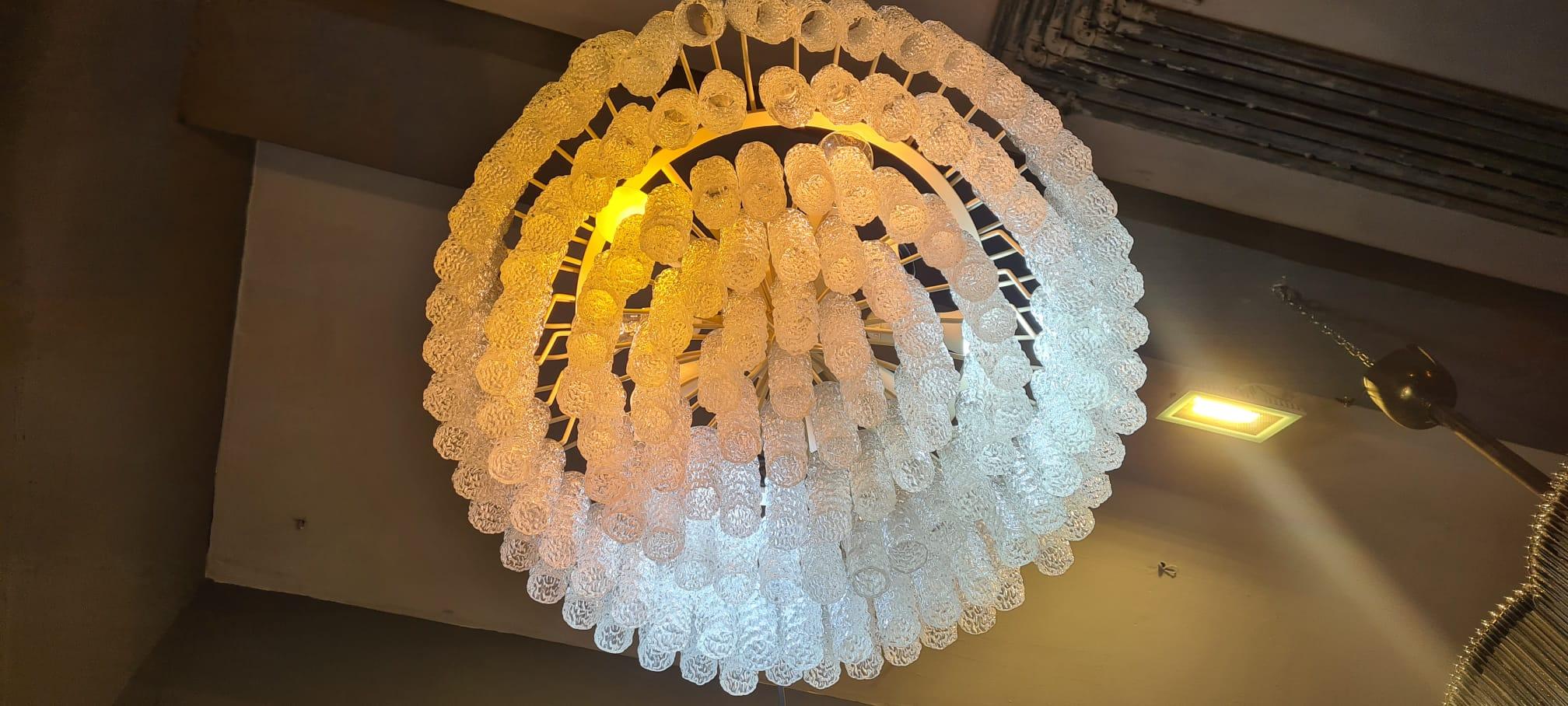 Murano glass chandelier with steel frame and glass produced by the most important Murano glass factory or Venini, the glasses were designed by master Toni Zuccheri.