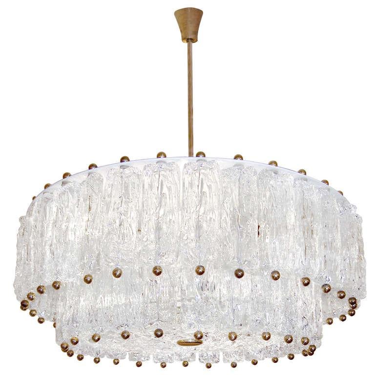 A textured glass fixture consisting of two tiers of multiple piece of glass hung around a texture glass disk with brass hardware by Venini. 

Italian, Circa 1960's

Four (4) Available.