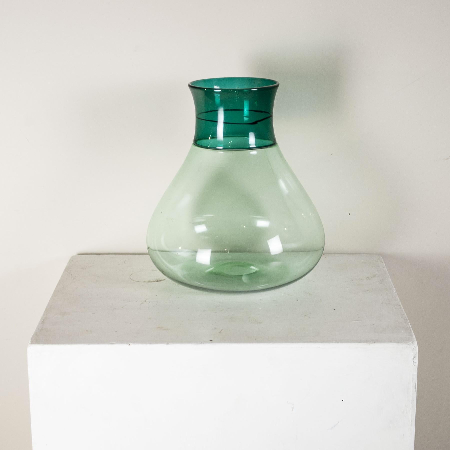 Colletti series vase in greenish blown glass with two-tone incalmo band decoration designer Alessandro Diaz de Santillana. Venini engraved signature.
After graduating in architecture in Venice, he immediately devoted himself to university