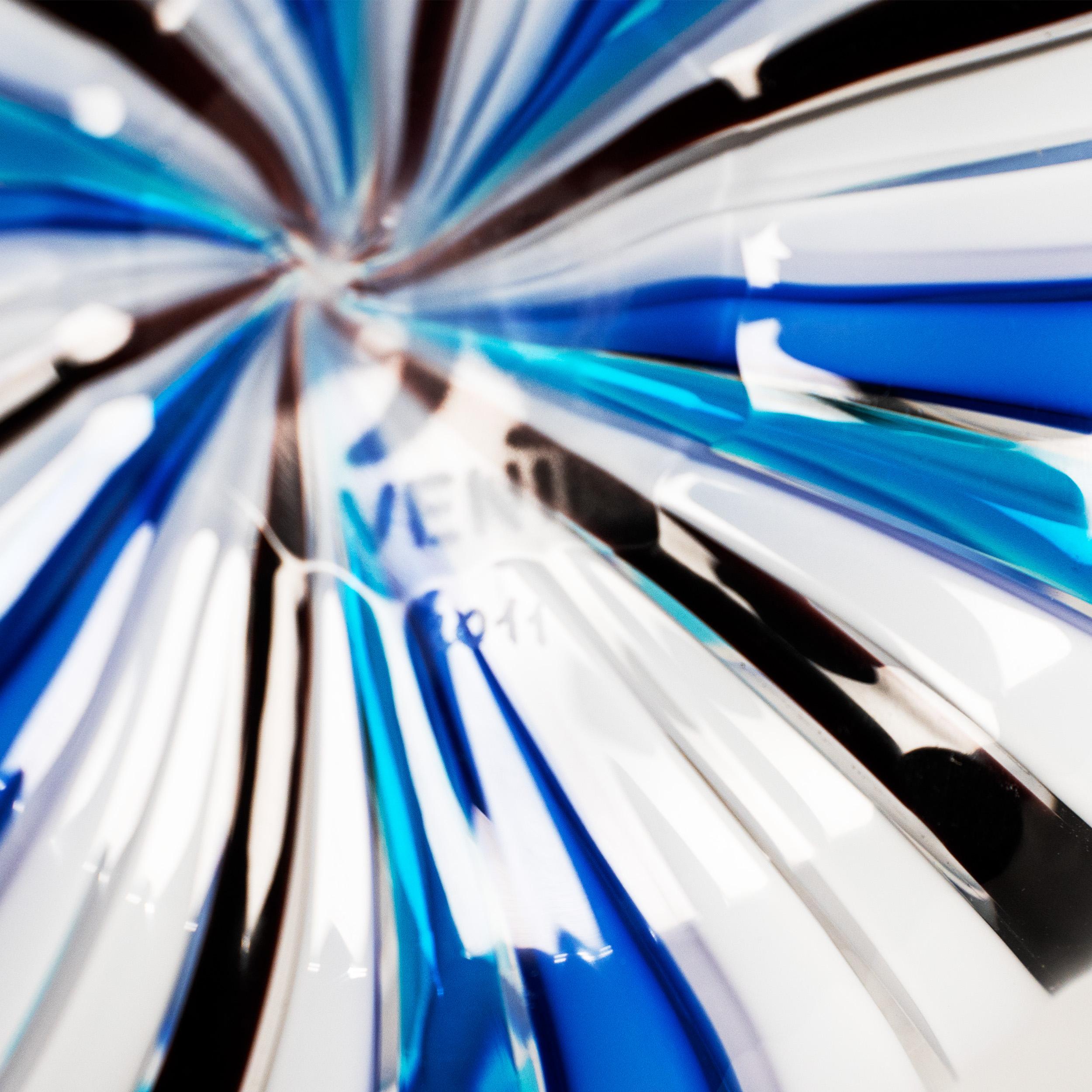 Vaso Fazzoletto a Canne soffiato a mano di Venini, modello 701.01, realizzato in vetro filigranato multicolore. Prodotto nel 2011 per commemorare il 90° anniversario di Venini (1921-2011).
Il vaso presenta l'iconico bordo a forma di 