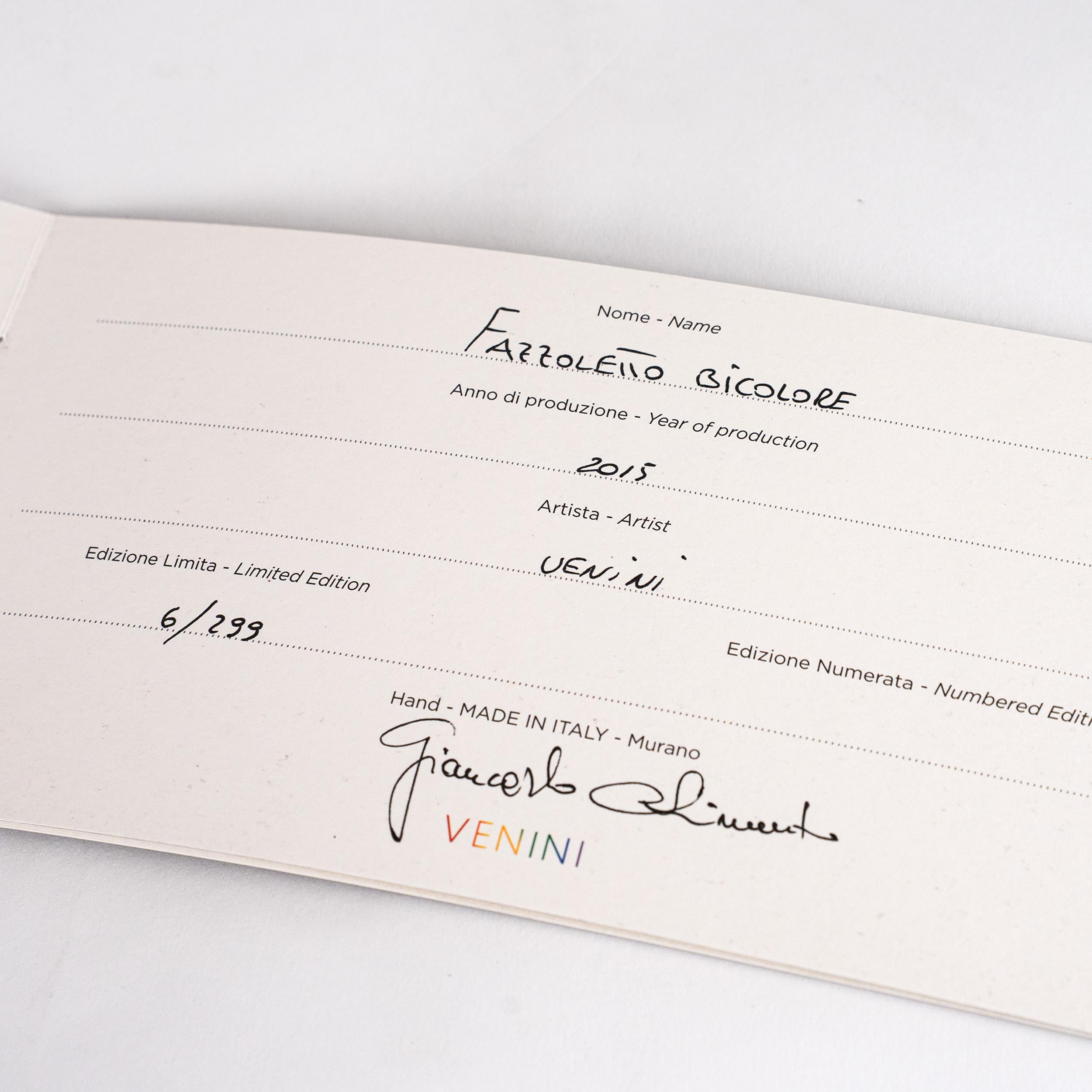 Iconico vaso Tre Punte di Venini Fazzoletto, modello 034.81, in vetro opalino grigio e rosso, edizione limitata 6/299, anno 2015. 
Non usato e conservato in ottime condizioni, il pezzo porta la firma di Venini ed è accompagnato dalla scatola e dal