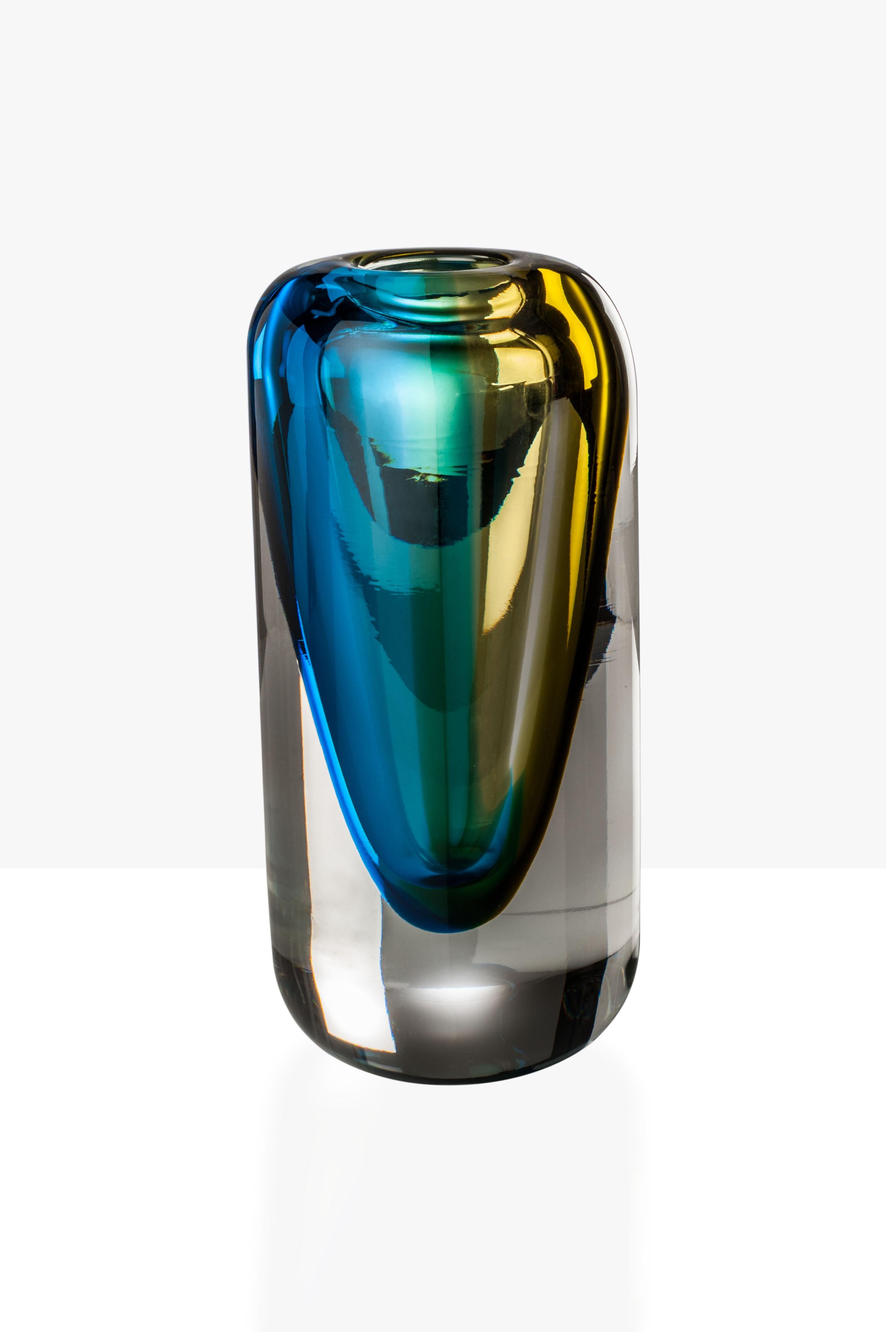 Venezia glass vase series, designed and manufactured by Venini, features two different shaped vases with crystal, aquamarine and bamboo colors. Limited edition of 19 art pieces per version. Indoor use only.

Dimensions: Ø 12 cm, H 25 cm.