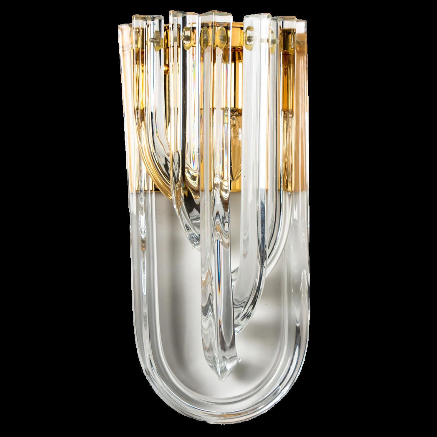 A beautiful and impressive Venini wall light, curved crystal glass and gilt brass, Italy.

The chandelier is made of curved crystal Murano glasses in different lengths. The flush mount has eight lights with 18 Murano crystal tubes and a gold-plated