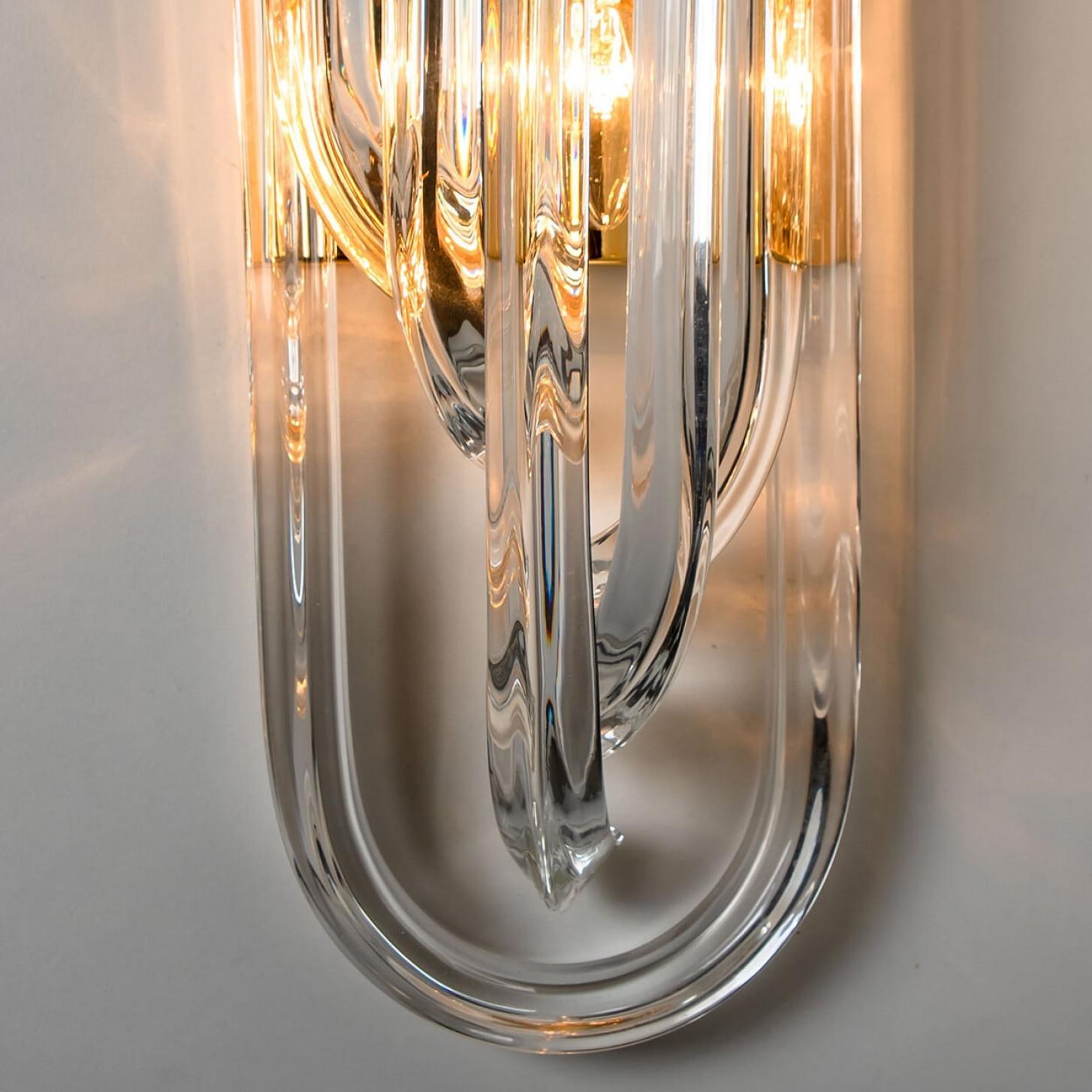 A beautiful and impressive Venini wall light, curved crystal glass and gilt brass, Italy.

The chandelier is made of curved crystal Murano glasses in different lengths. The flush mount has eight lights with 18 Murano crystal tubes and a gold-plated