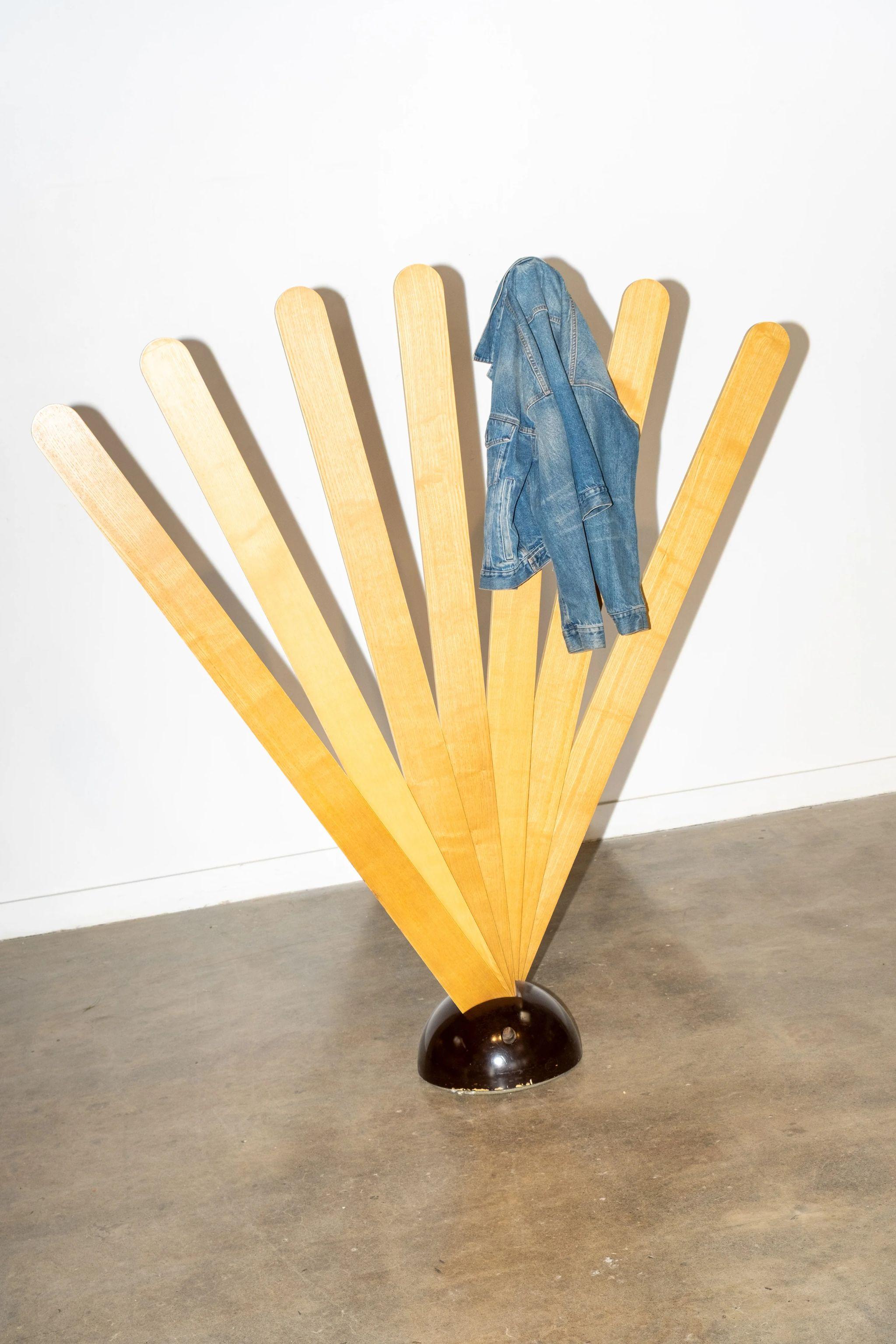 A sculptural wonder, Giovanni Pasotto's 'Ventaglio' Coat Hanger is as fun as it is functional. Opens and closes as the user requires. The weighted base keeps the piece solidly in place. Note some chips of missing paint at bottom edge of base.