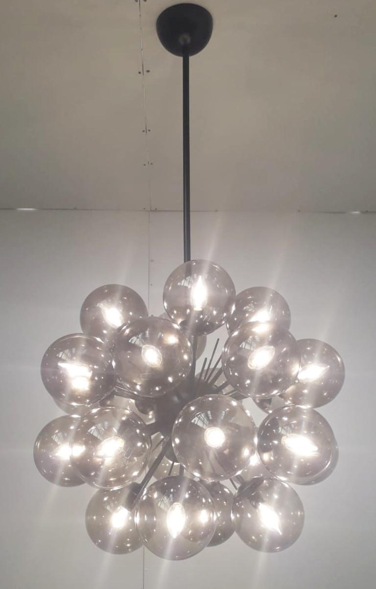 Italian sputnik chandelier with 24 Murano glass globes mounted on metal frame in matte black powder coated finish / Designed by Fabio Bergomi for Fabio Ltd / Made in Italy
24 lights / E12 or E14 type / max 40W each
Diameter: 28 inches / Height: 47