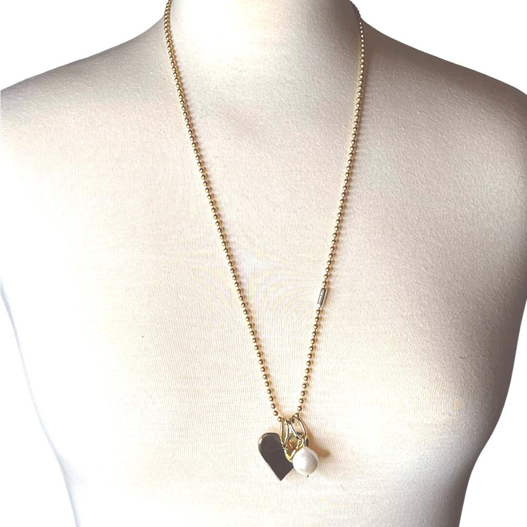 28 inch necklace beautifully shows a freshwater pearl and a brass heart charm on a 3mm ball chain. Perfect on its own or layered. Imperfections on surface is intentional for an unearthed look as the years go by.

Materials: Recycled Brass Heart with