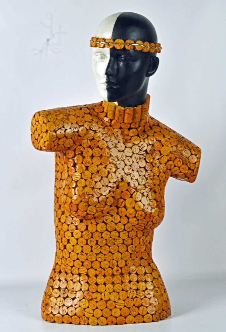 Standing 29.5 inches tall this sculpture of a female torso covered with slices of wine corks and with her head painted black and white make a fetching contemporary impression with a humorous yet fashionable note. The artist has inserted his title of