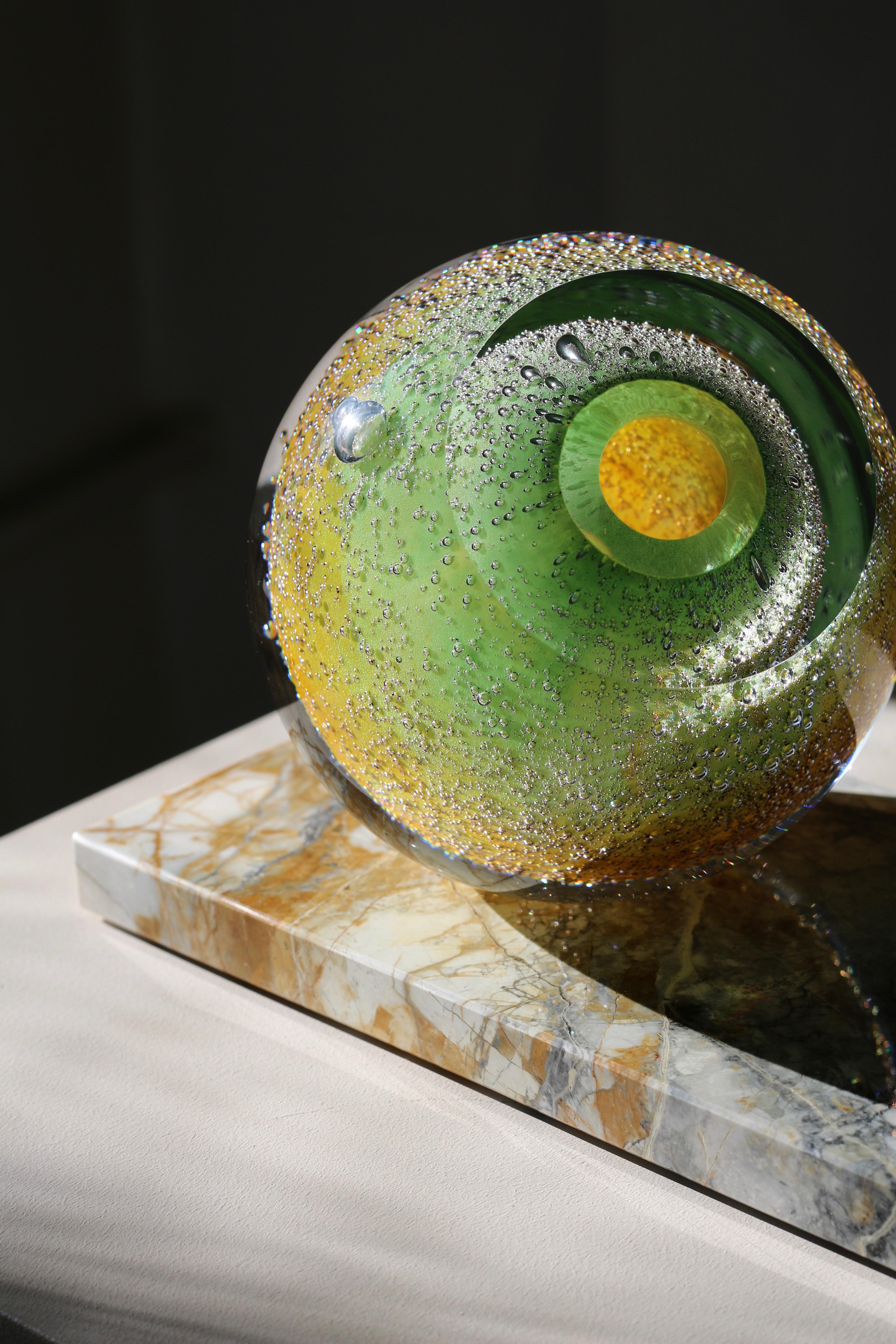 'Venus Eye' freeform mouth-blown glass vase on Côte d'Azur marble. 
Extra-clear top quality and lustrous glass tinted in warm green to grey. 
This contemporary small scale sculpture is a unique piece from collection Experimental. 
Design and