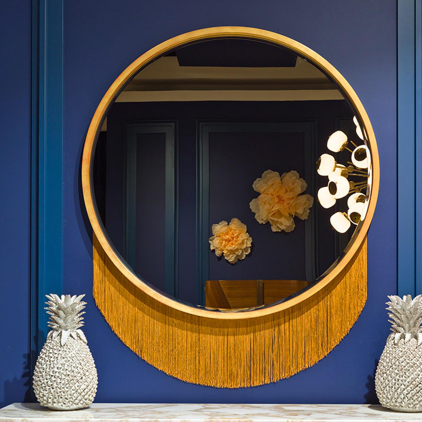 Brimming with minimalist appeal, this captivating wall mirror is a sophisticated way for brightening up any midcentury or minimalist interior with style. The mirror's prominent circular silhouette is fashioned of wood with a gold-leaf finish, which