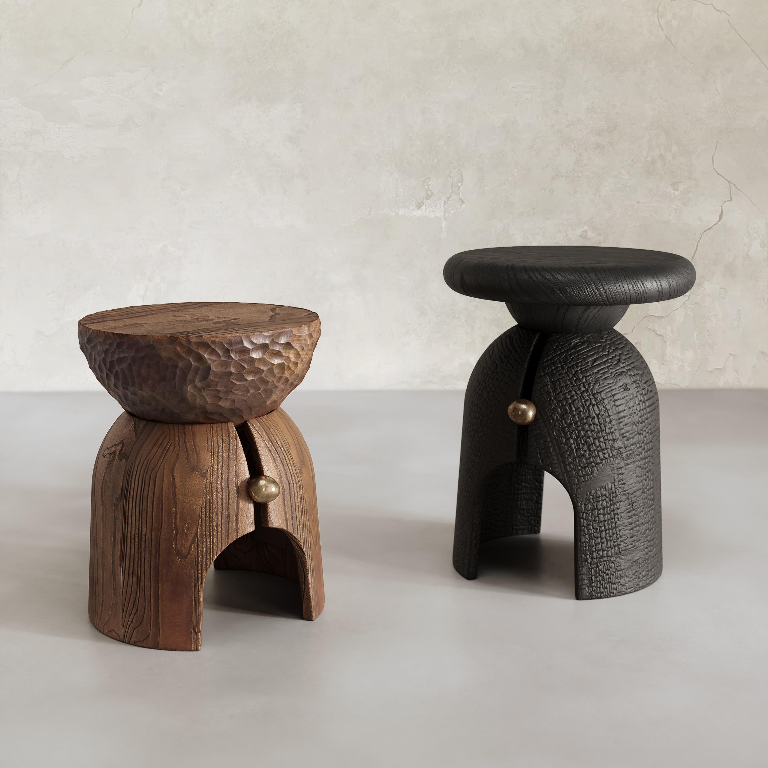 The Venus Side Table is a unique piece of furniture handcrafted using a traditional Japanese technique called Shou Sugi Ban, which involves charring the wood to create a textural surface. The table combines solid wood and liquid bronze, ensuring