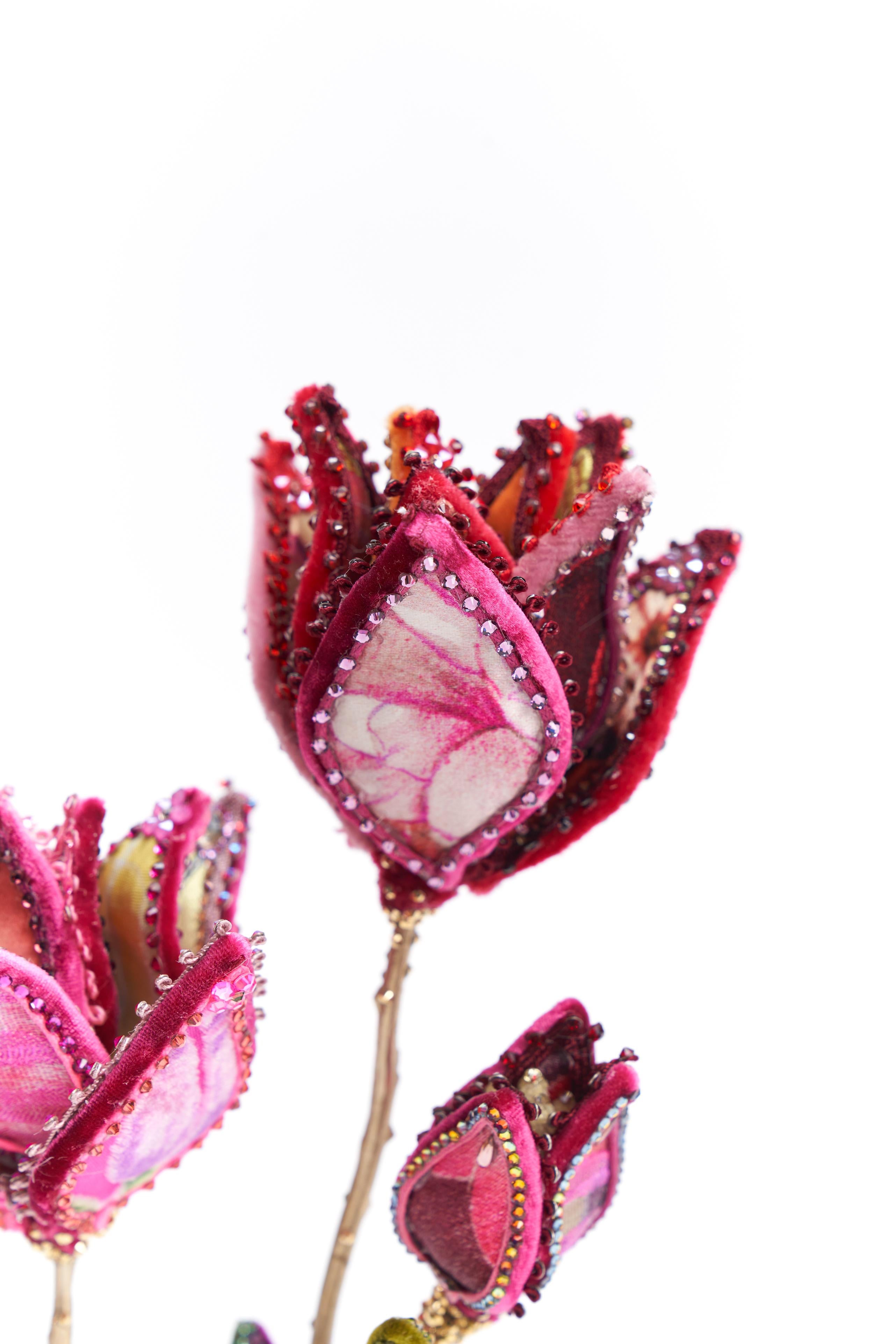 Red & Pink Tulip in silk and velvet resting upon a bulb-shaped brass base. Exceptionally detailed leaves feature one-of-a-kind designs on each piece. Adorned with vintage millinery embellishments, European crystals, and vintage faux-stamen. Designed