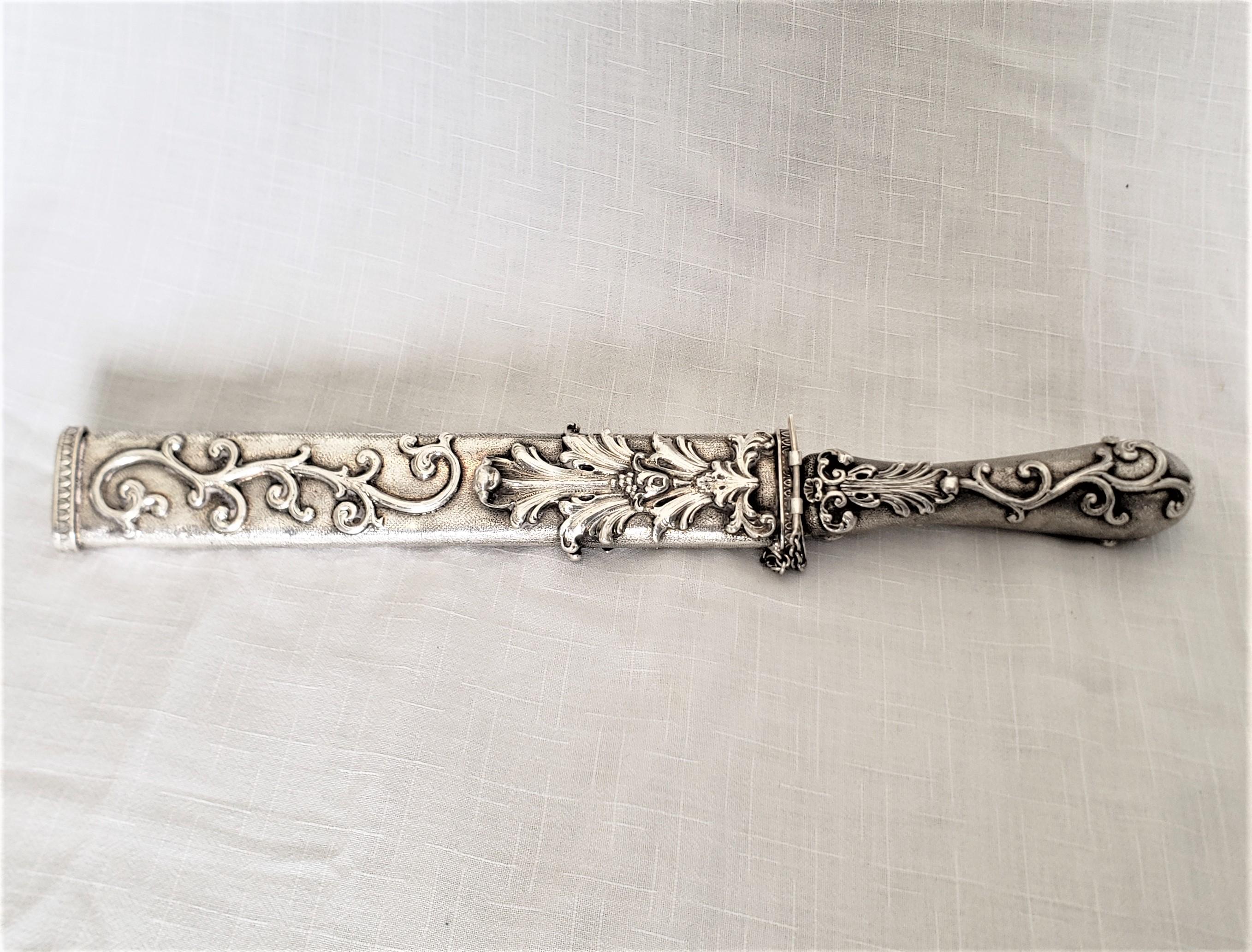 This antique styled Italian knife and scabbard set was made as part of the Vera Jardin Collection, and dates to approximately 1920-60 and done in a Renaissance Revival style. The set is highly decorative and may have been produced as a letter opener