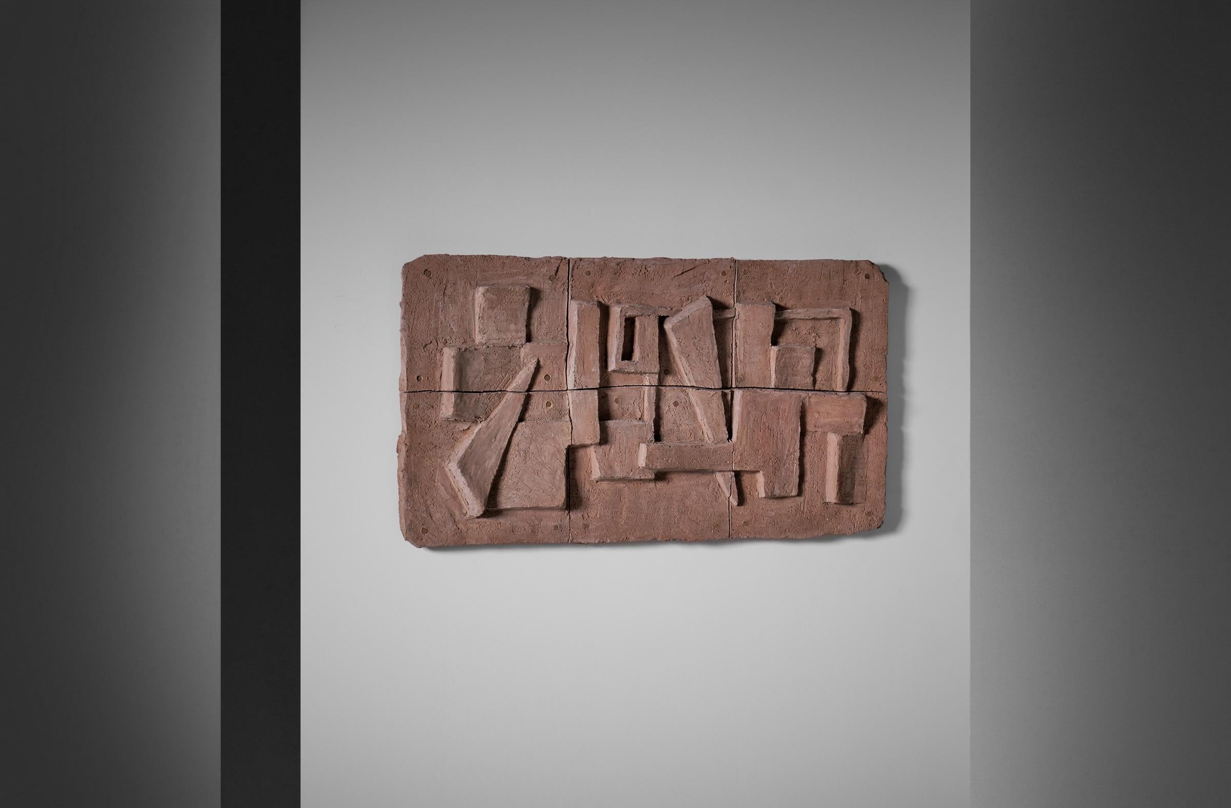 Abstract Wall relief by Vera Kapisoda, France 1960's. The artwork is made from chamotte clay and is showing a composition of interesting abstract shapes. The work is very dynamic due to the relief and structured surface which catches the light in a