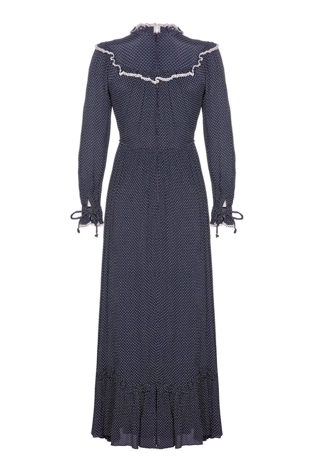 This enchanting Vera Mont 1970s prairie dress with high-collar neckline and ruffle detail is a fine example of this classic style. The lightweight crepe overlay is a deep navy with white micro dot formation surface design. The collar is a close