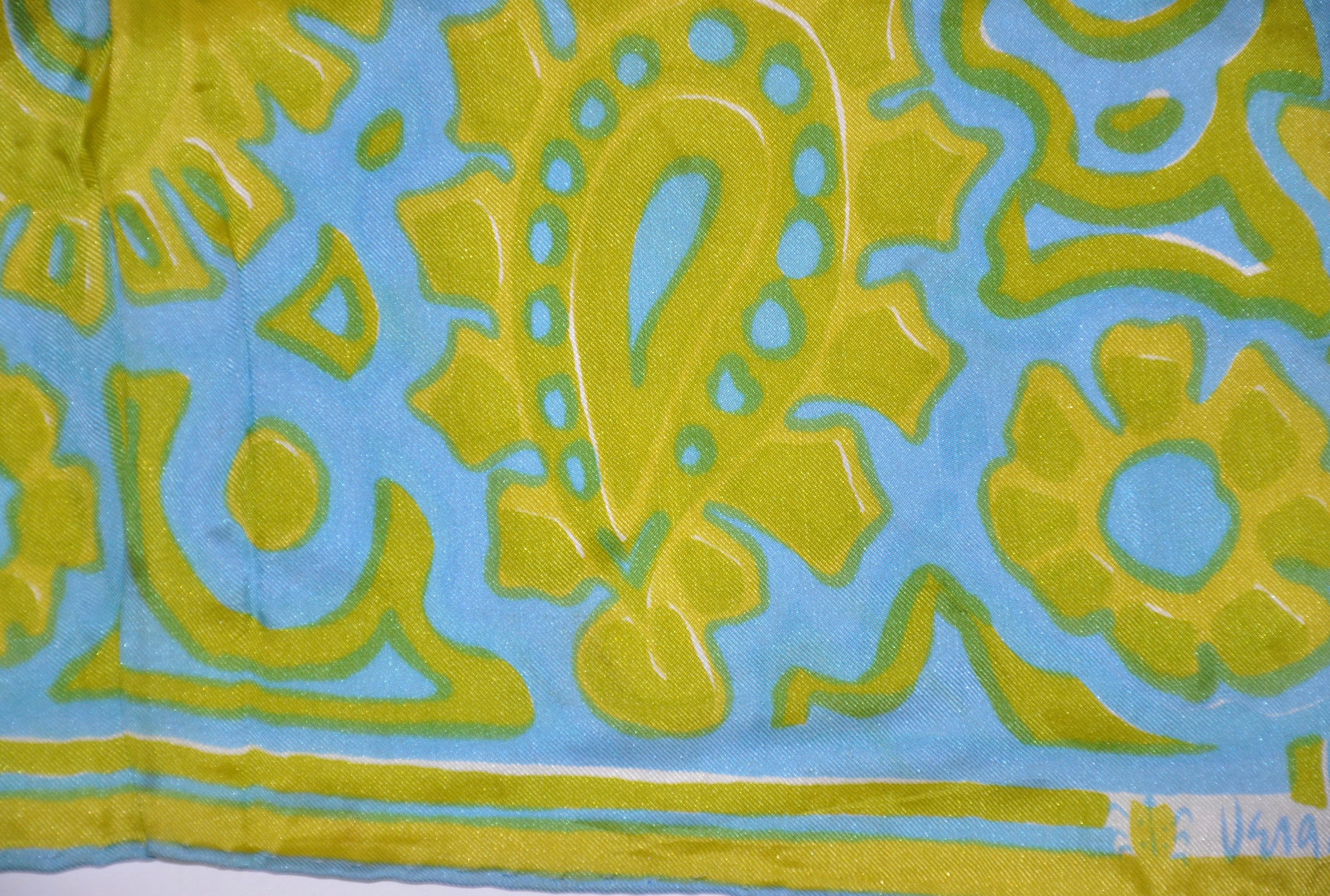        Vera whimsical turquoise and lime 'abstract palsey' print silk scarf is finished with hand-rolled edges and measures 44 inches by 14 1/2 inches. Made in Japan.