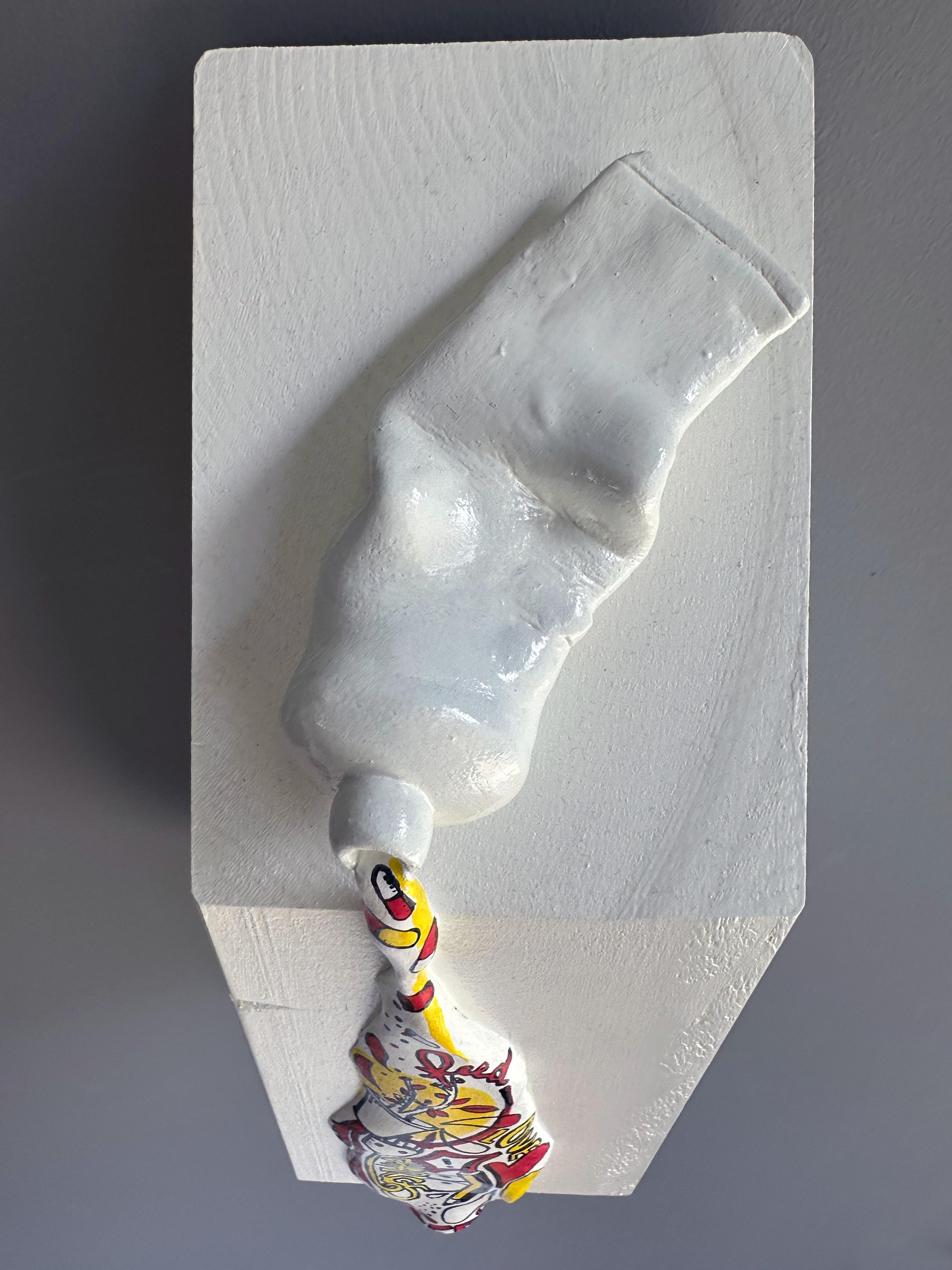 IN A WHILE (2025) is a small-scale, wall-mounted mixed-media sculpture by Vera Vizzi that transforms a familiar domestic object into a sculptural encounter. Hand-modeled in foam clay and applied onto a compact wooden block (25 x 9 x 10 cm), the work
