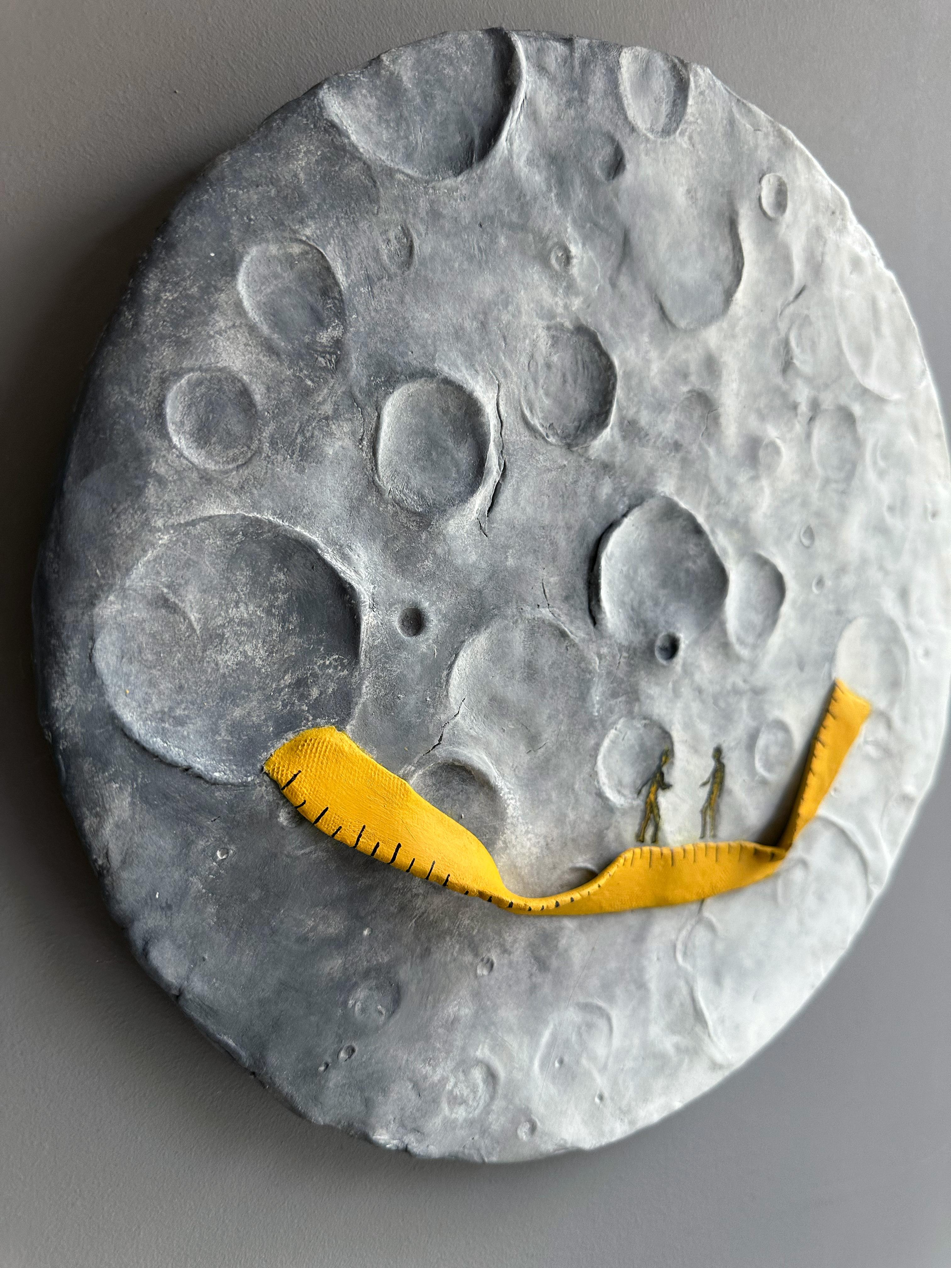 Foam clay, acrylic and enamel on fir wood circular relief that combines lunar bas-relief with a measured, stitched yellow band; a mixed-media wall sculpture engaging lunar topography and intimate encounter. Foam clay and acrylic on fir wood appear