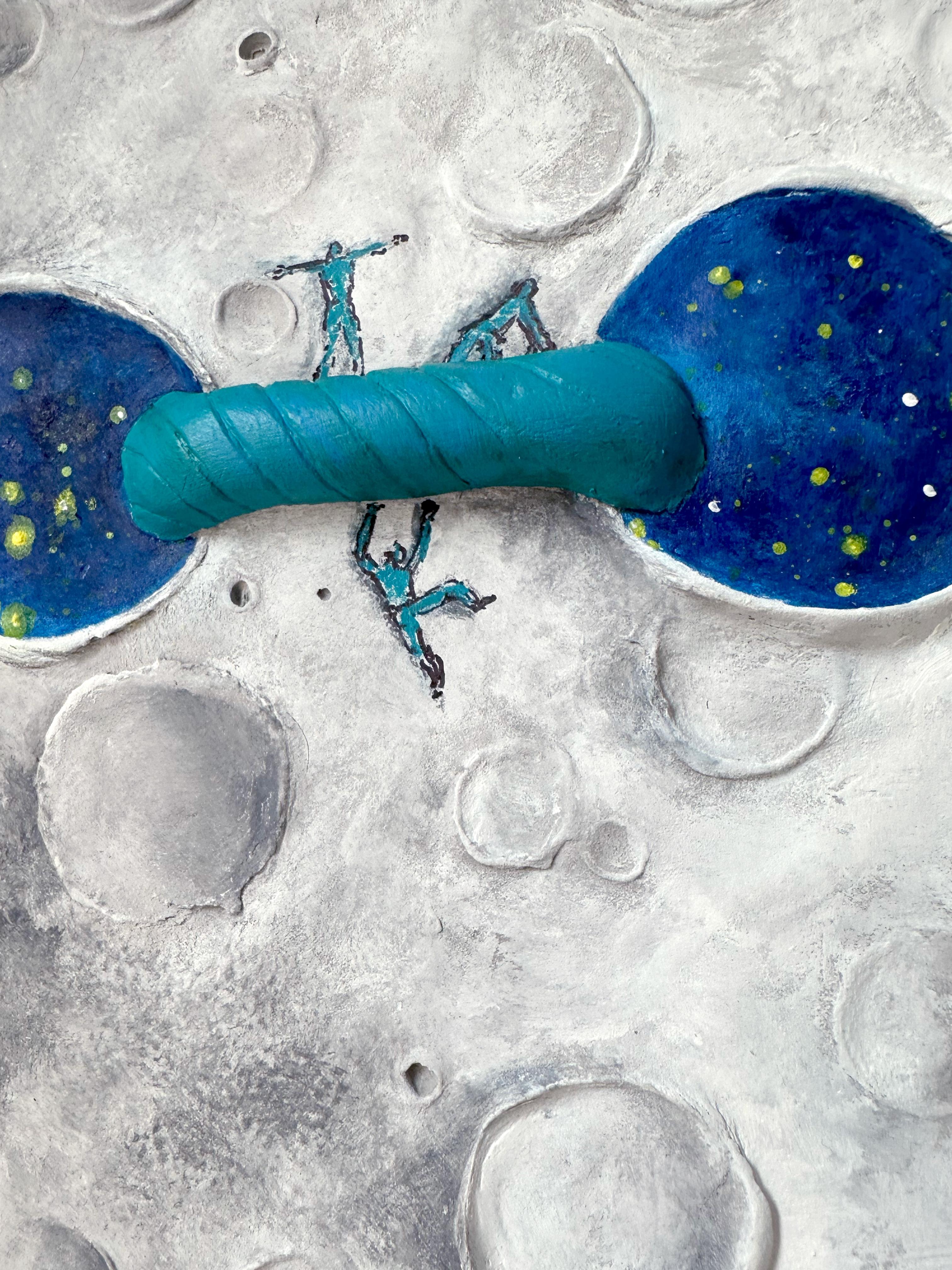 THE SAME is a mixed media wall sculpture by Vera Vizzi that renders the lunar surface as both stage and symbol. Modeled in clay and acrylic on a 30 cm Ø fir wood disc, the piece presents a cratered grey relief interrupted by two blue apertures—deep,