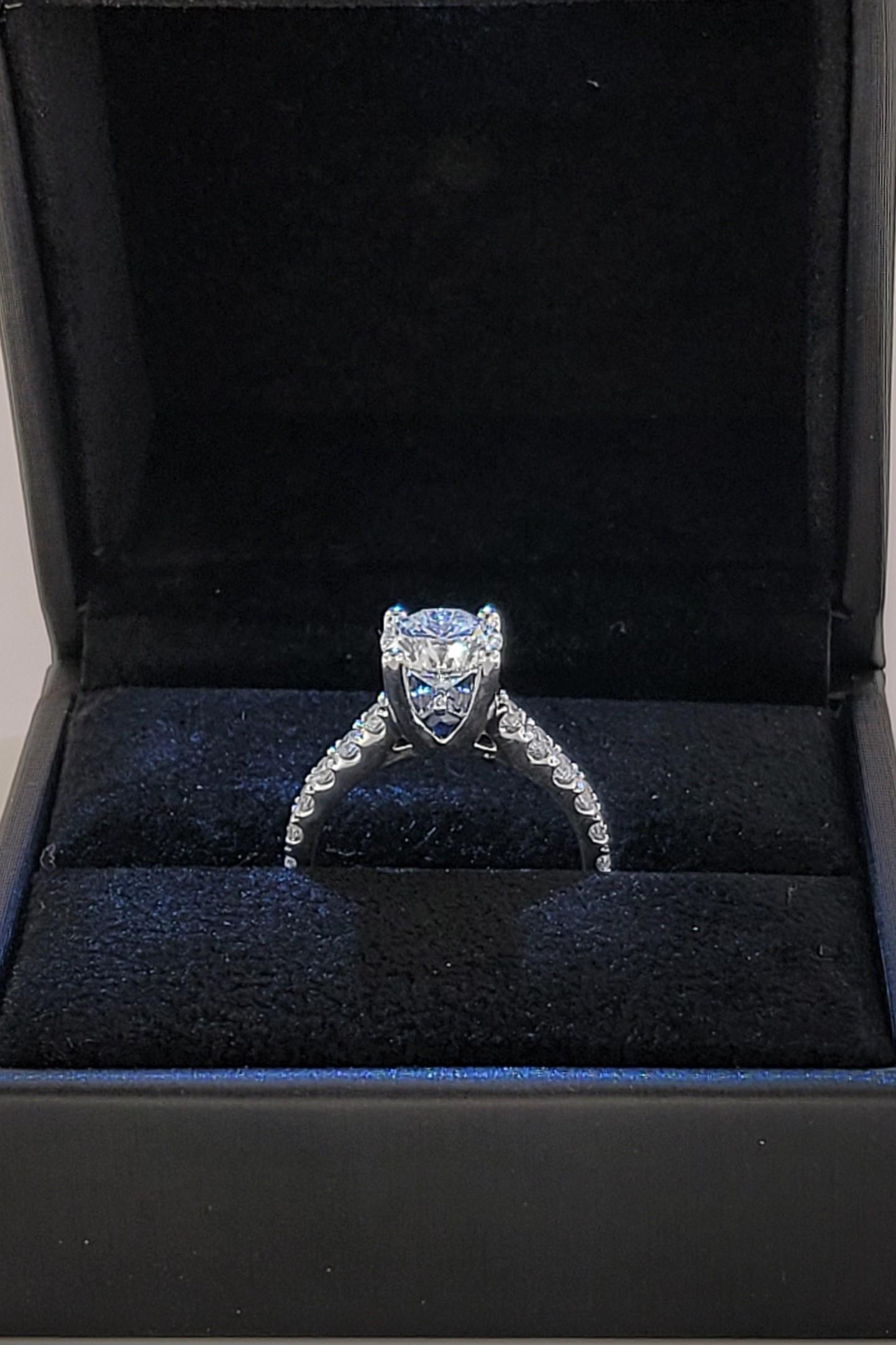 14K white gold engagement ring with 
 round brilliant diamond 
 center stone and round brilliant accent diamonds
 and genuine blue sapphire accents. 
 Ring Size 6.75
 Stone shape round
 Center -1.70ct /Side 0.50ct
 Color Grade Center -I / Side G-H
