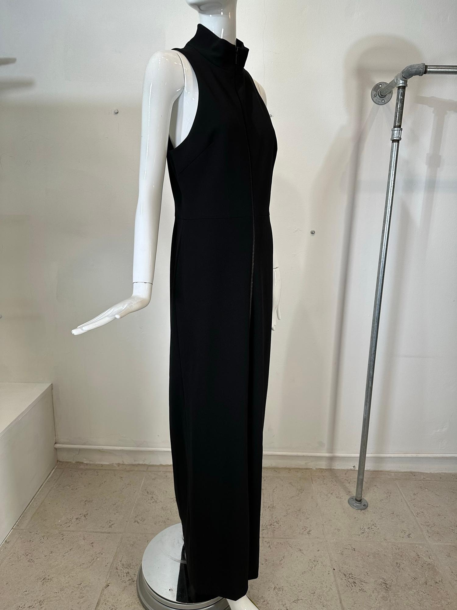 Vera Wang black knit jersey maxi dress with racer shoulders, band neck & zipper front. Fitted through the torso, the dress falls in an A line to the hem. There is a 28