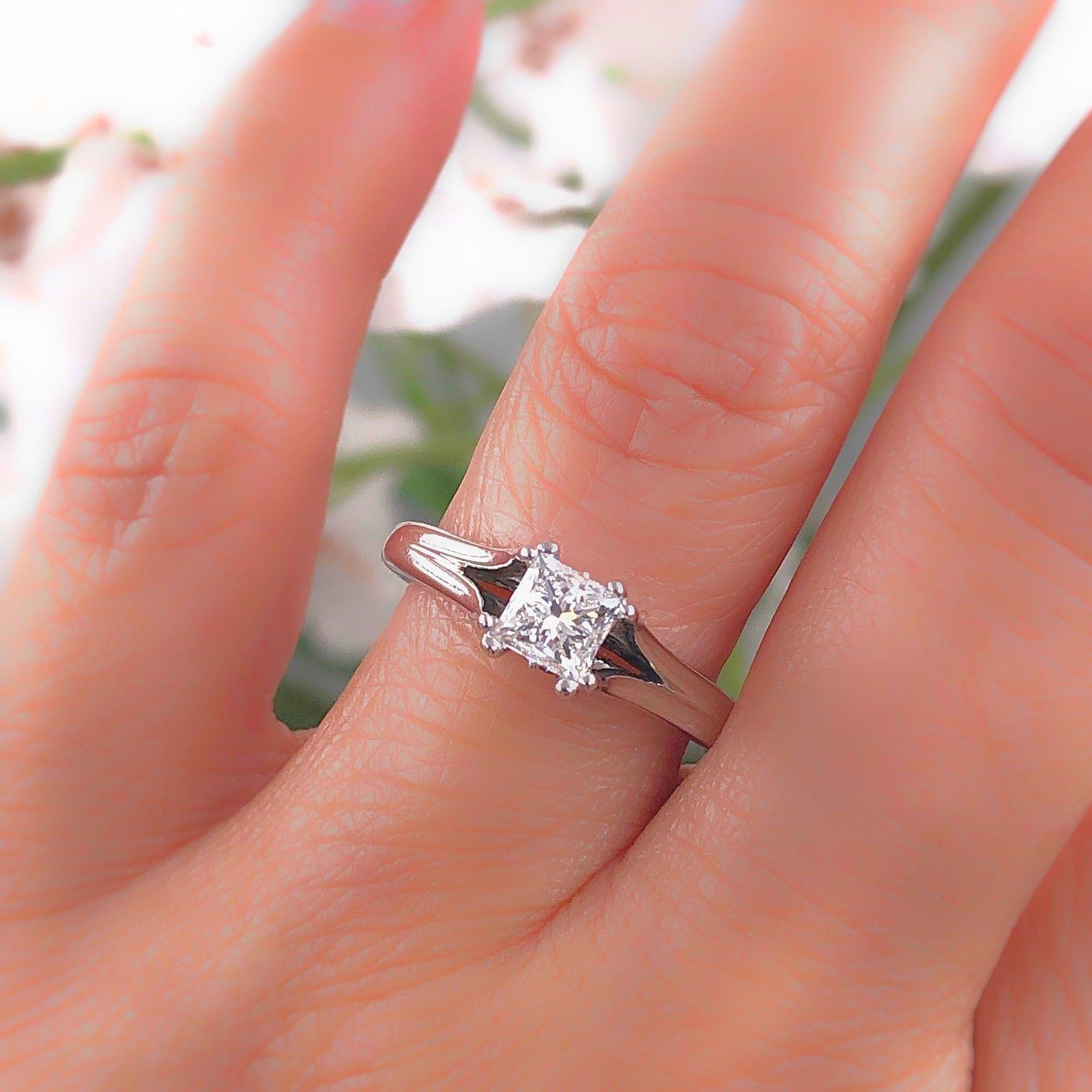 VERA WANG Diamond Engagement Ring
Style:  Split Shank Solitaire
Metal:  18kt White Gold
Size:  6.25 - sizable
Total Carat Weight:  0.85 tcw
Diamond Shape:  Princess Cut 0.60 cts H - I color, SI2 - I1 clarity
Accent Diamond:  12 Round Cuts & 2 Square
