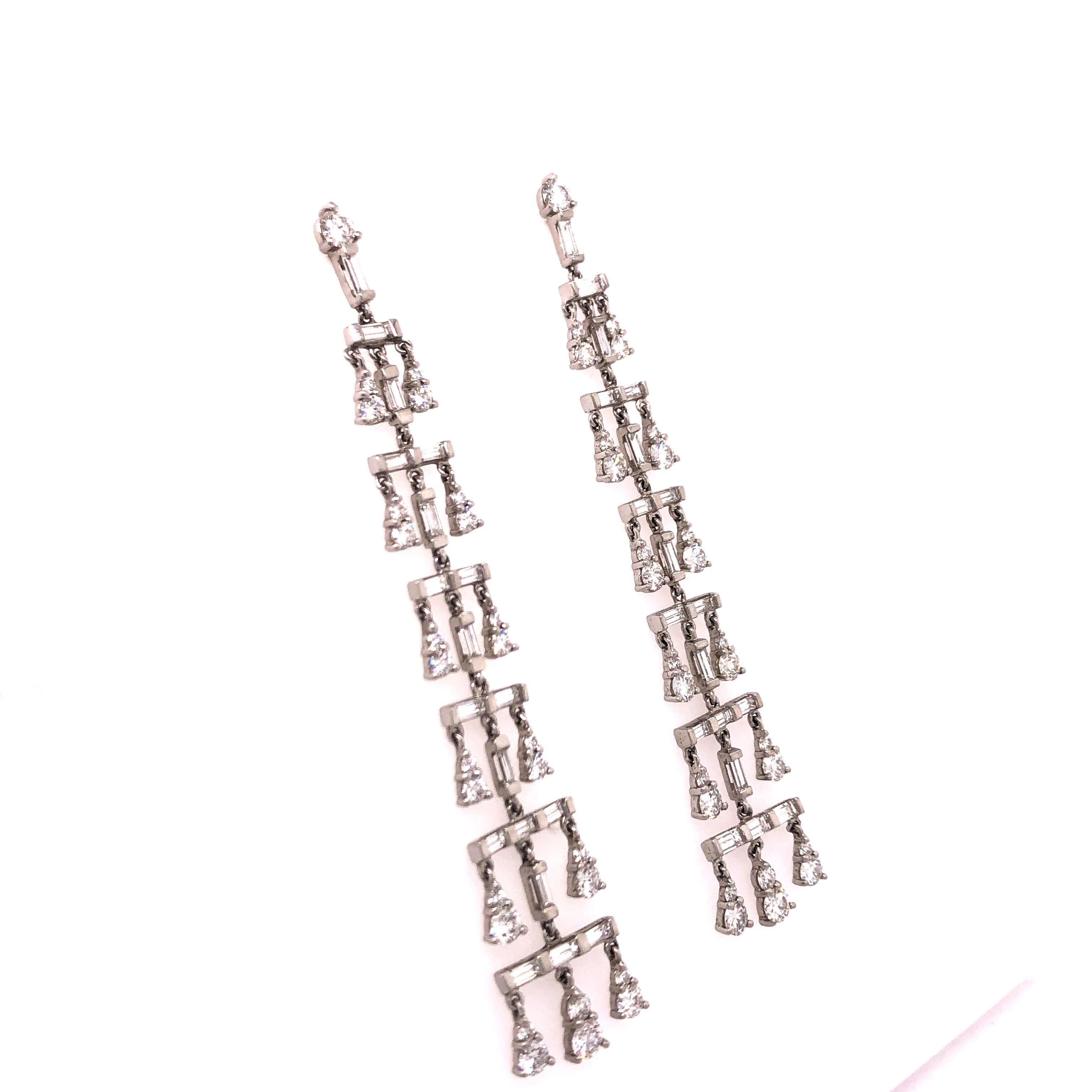 Vera Wang is famous for her gorgeous couture designs and that same beauty is seen in these Platinum Diamond Chandelier Earrings. A pattern of baguette and round diamonds give the appearance of drops of water that taper down as if from a fountain.